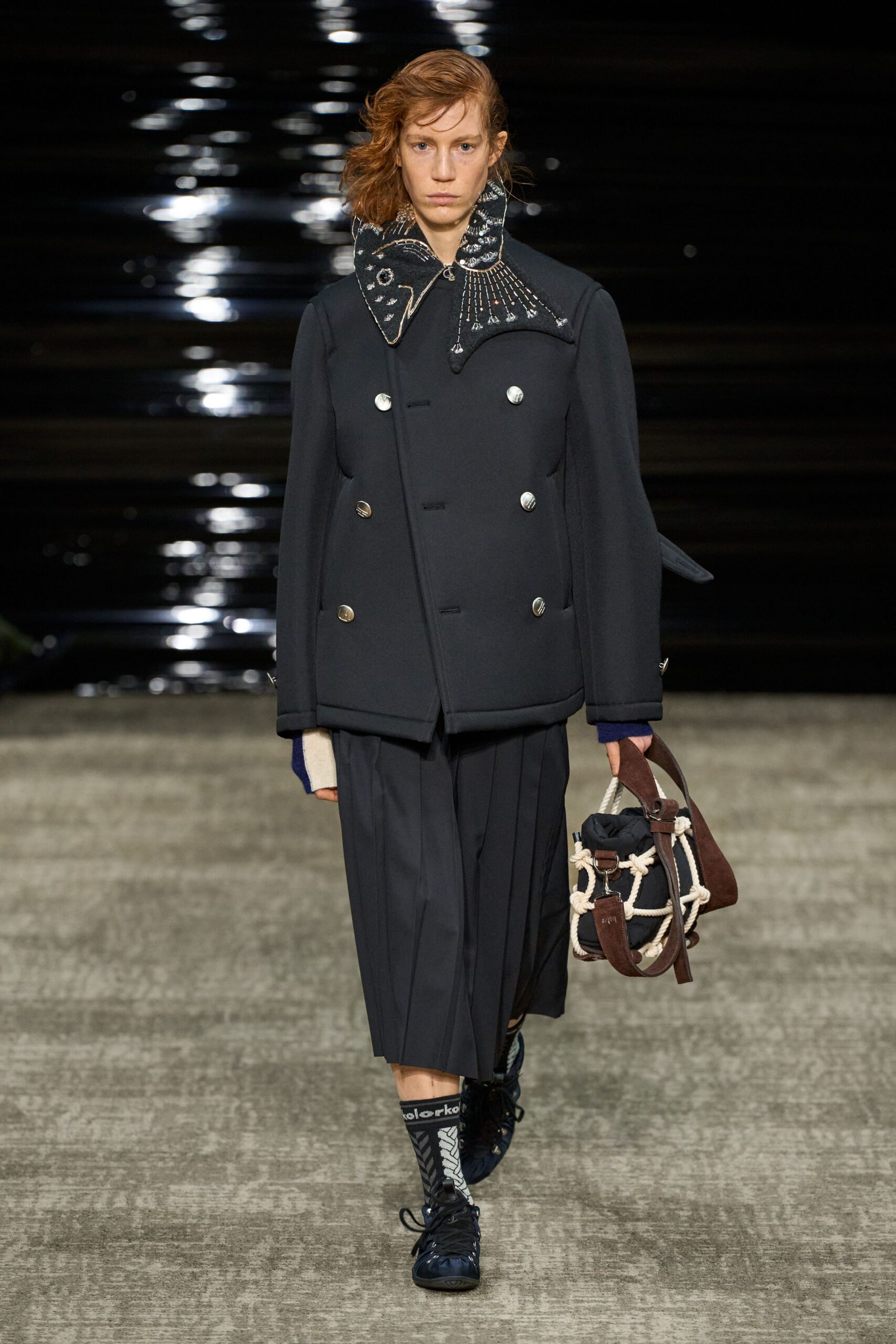 black wool coat with pleated pants