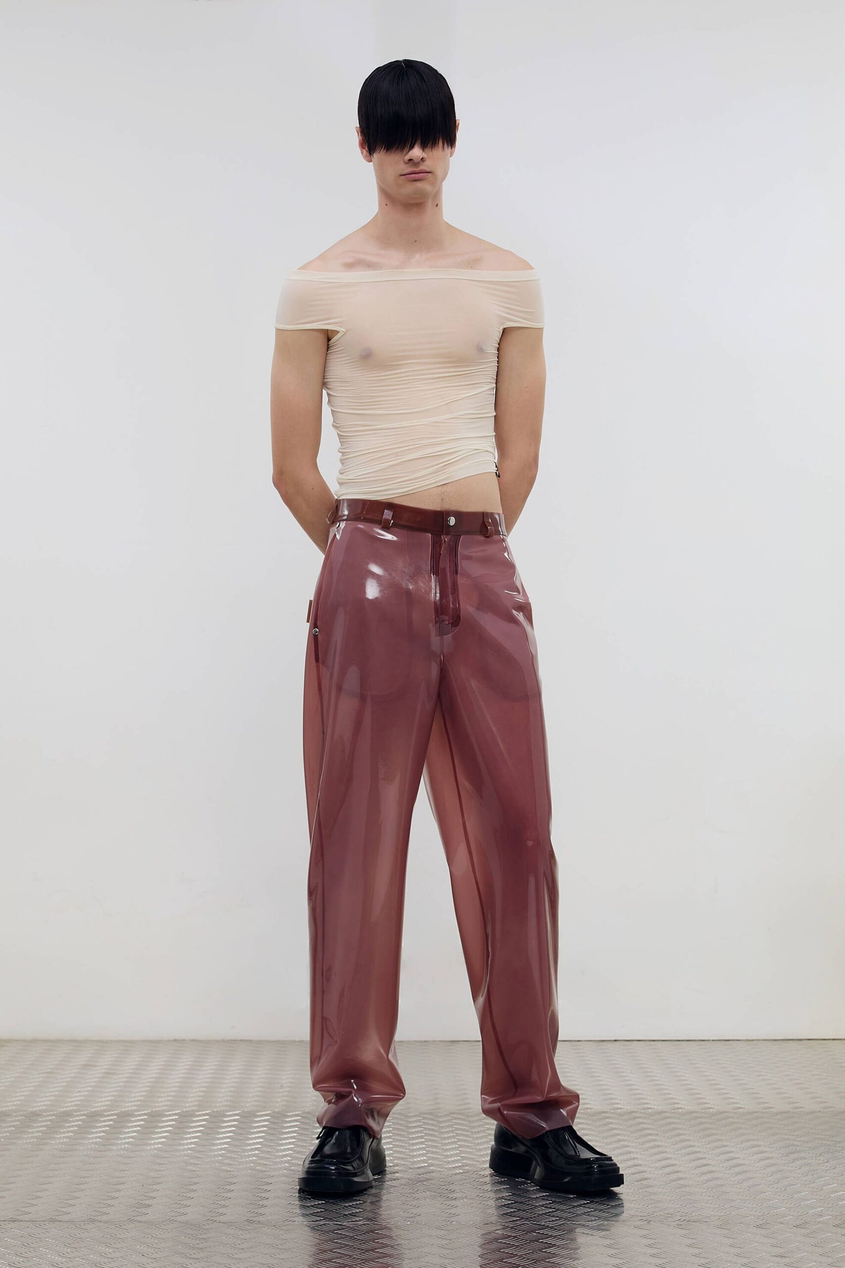beige off-shoulder top with pink vinyl pants