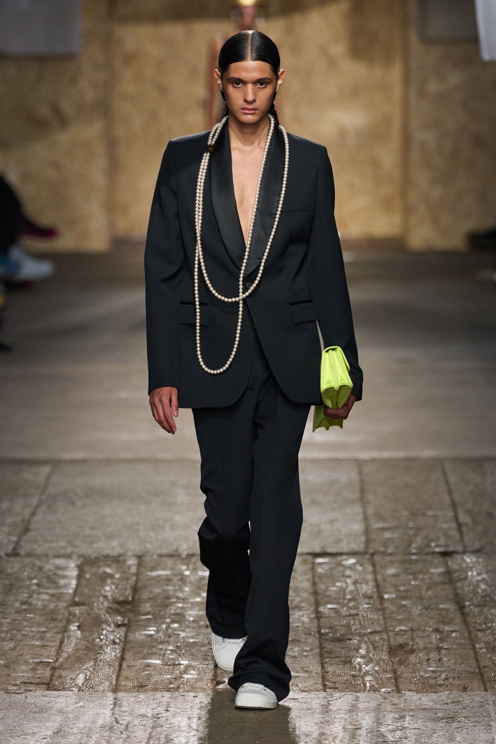 black tailored suit with green bag