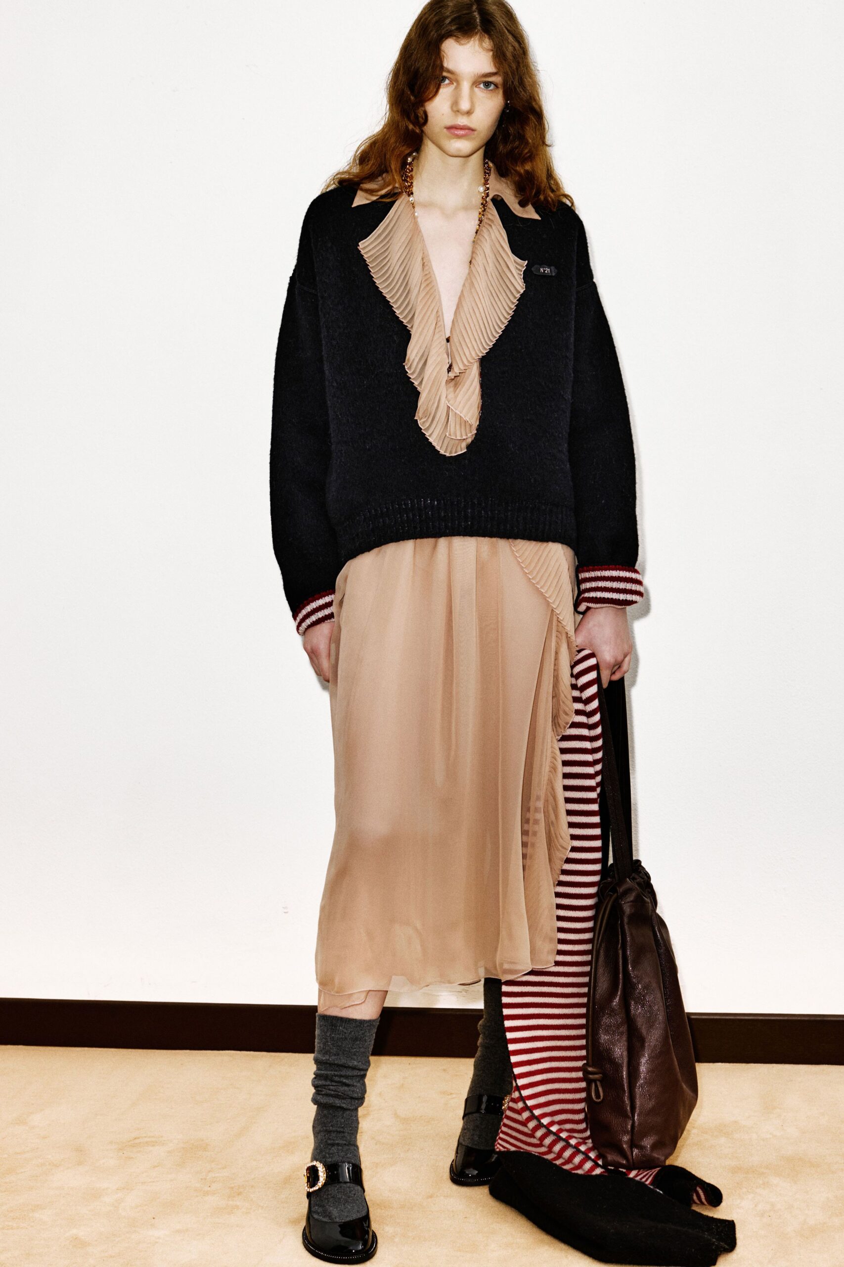 black wool relaxed sweater and beige striped dress