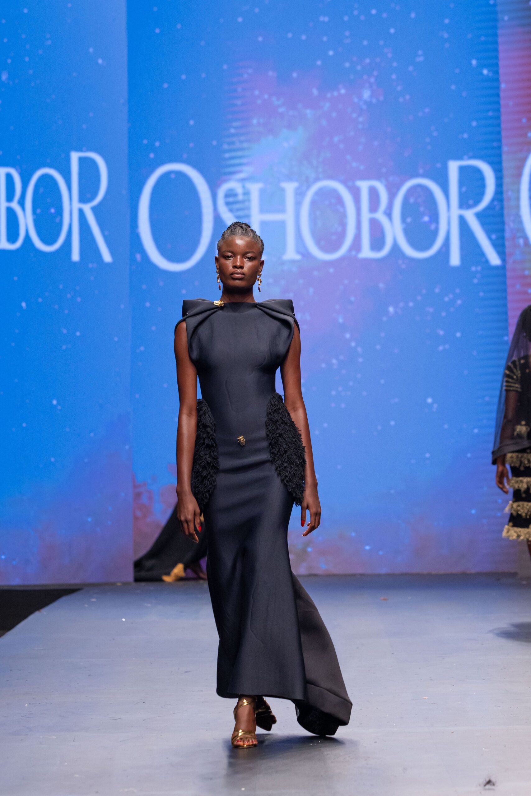 black silk fitted gown with gold shoes