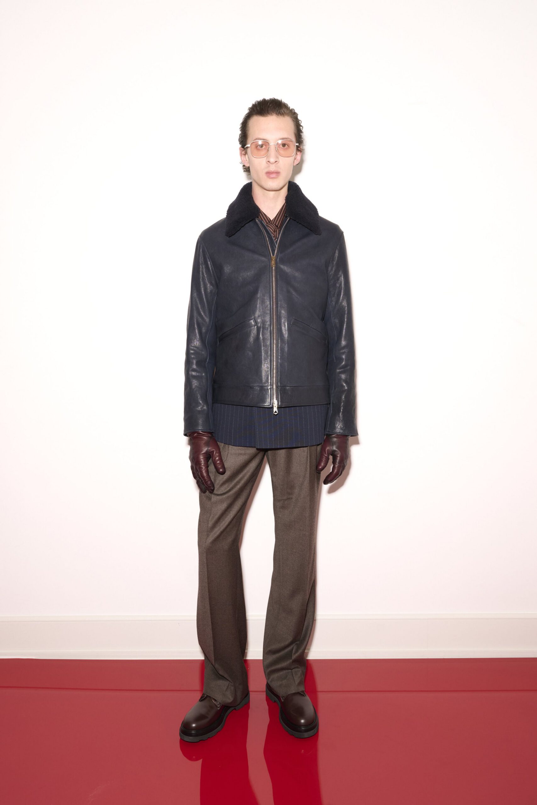 blue leather jacket with gray pants