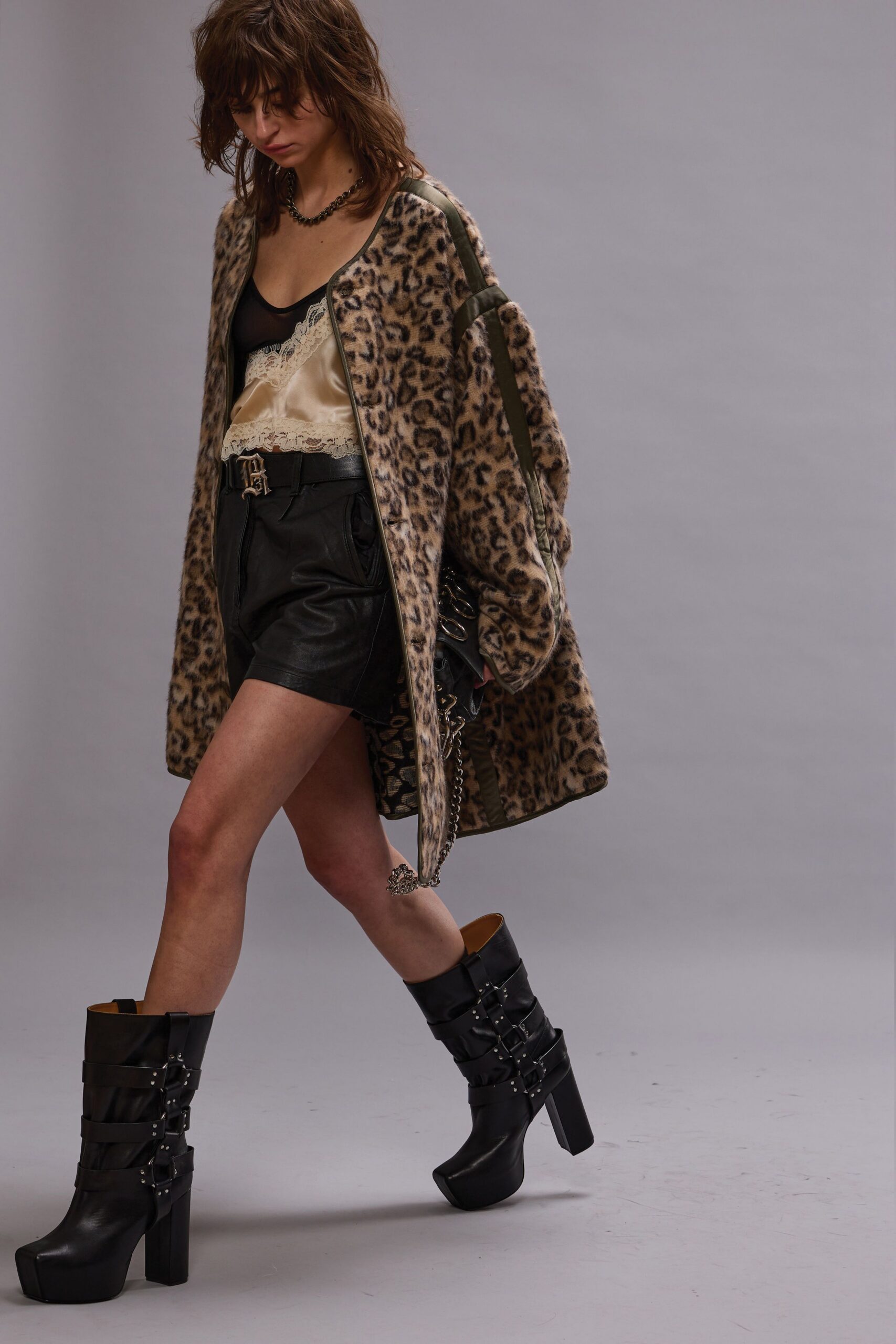 brown faux-fur coat with black leather shorts