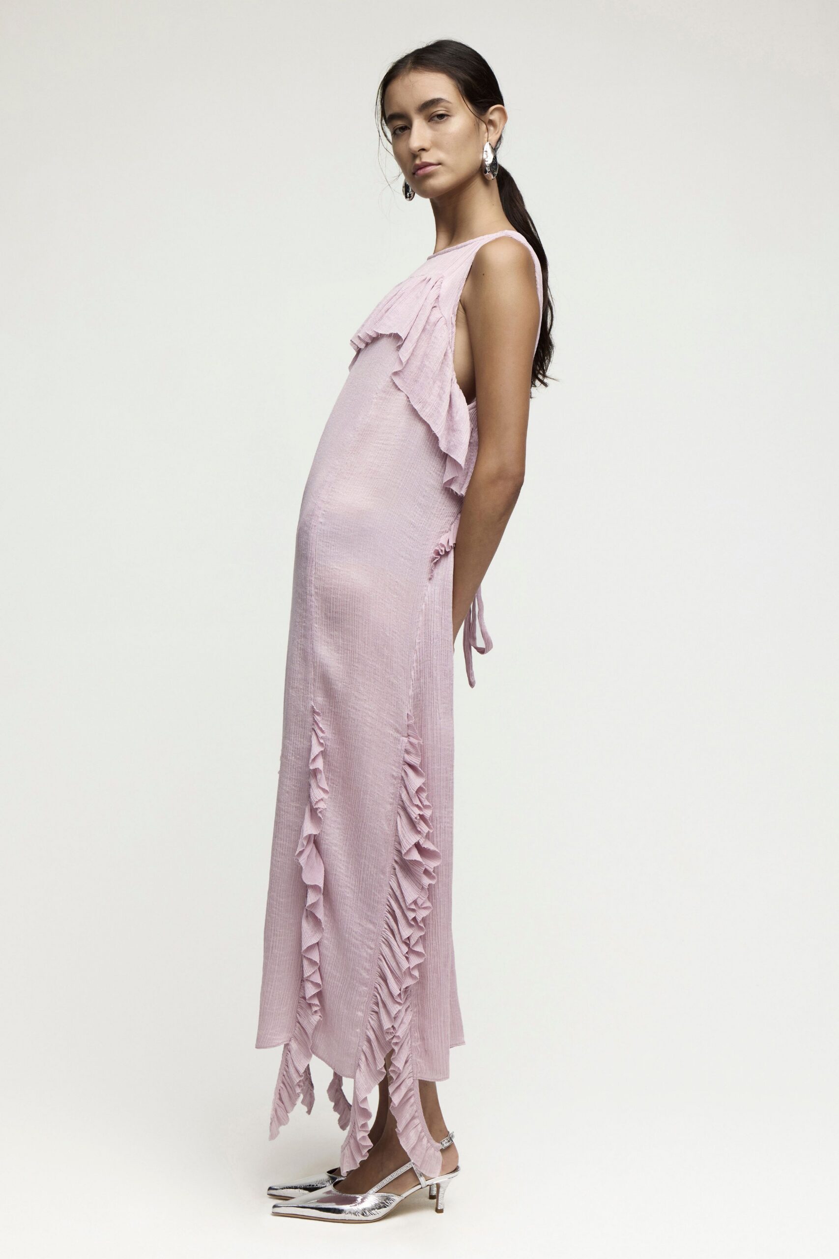 pink ruffled midi dress with silver shoes