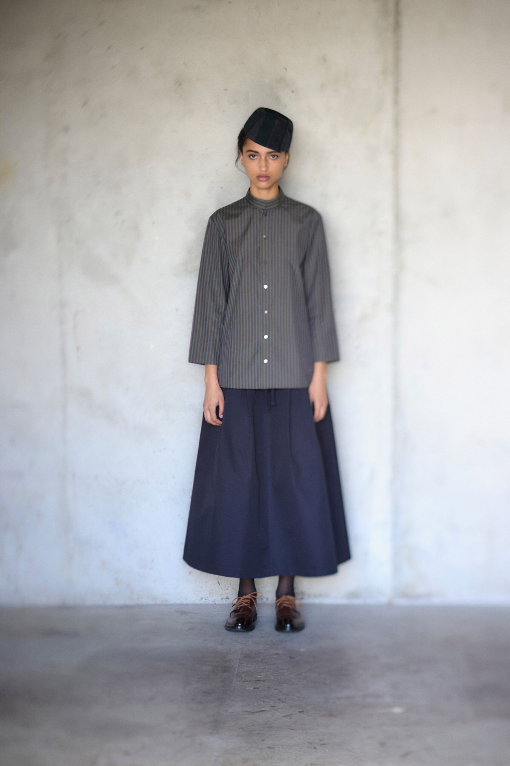 gray striped shirt black midi skirt
