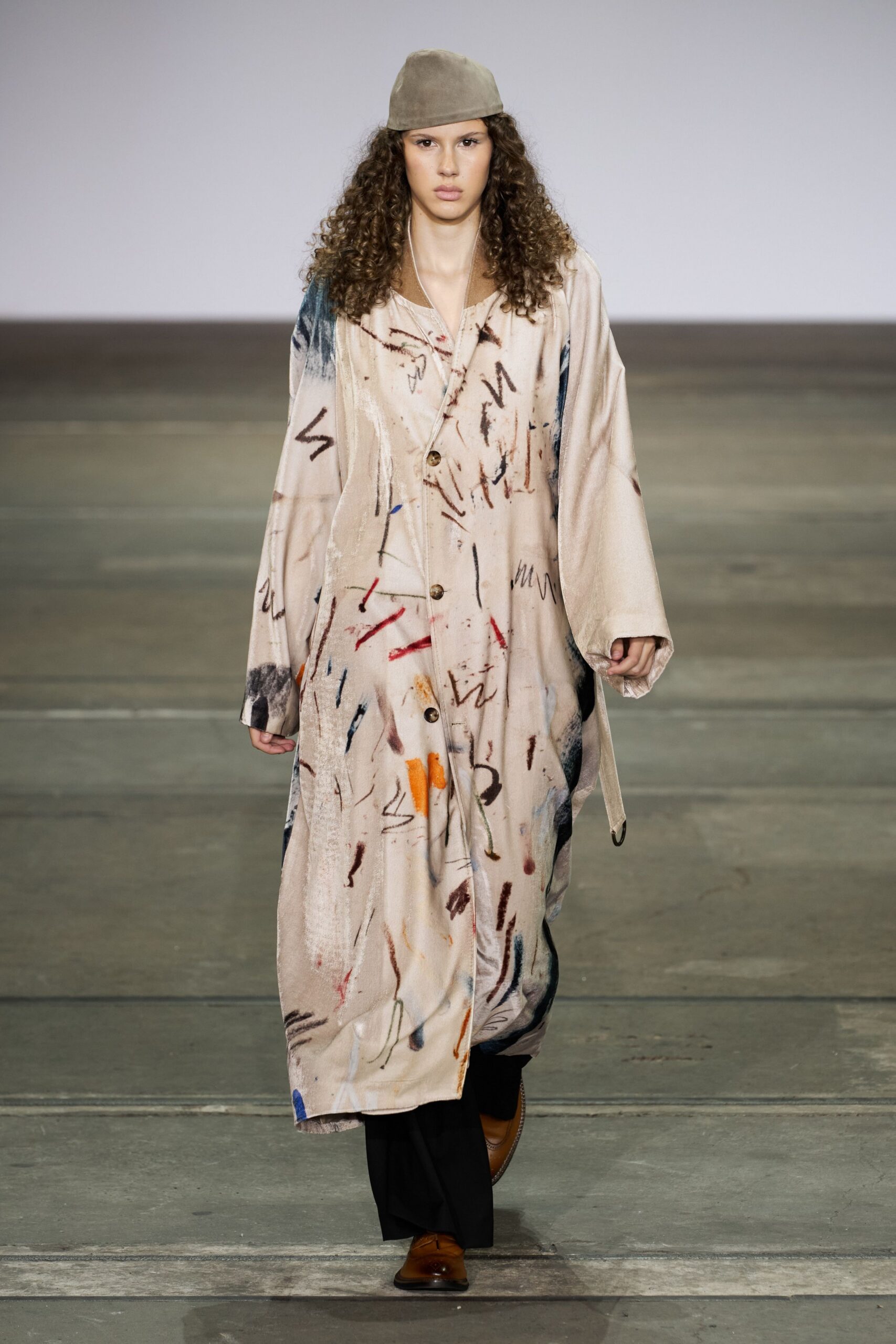beige multi-colored coat with black pants