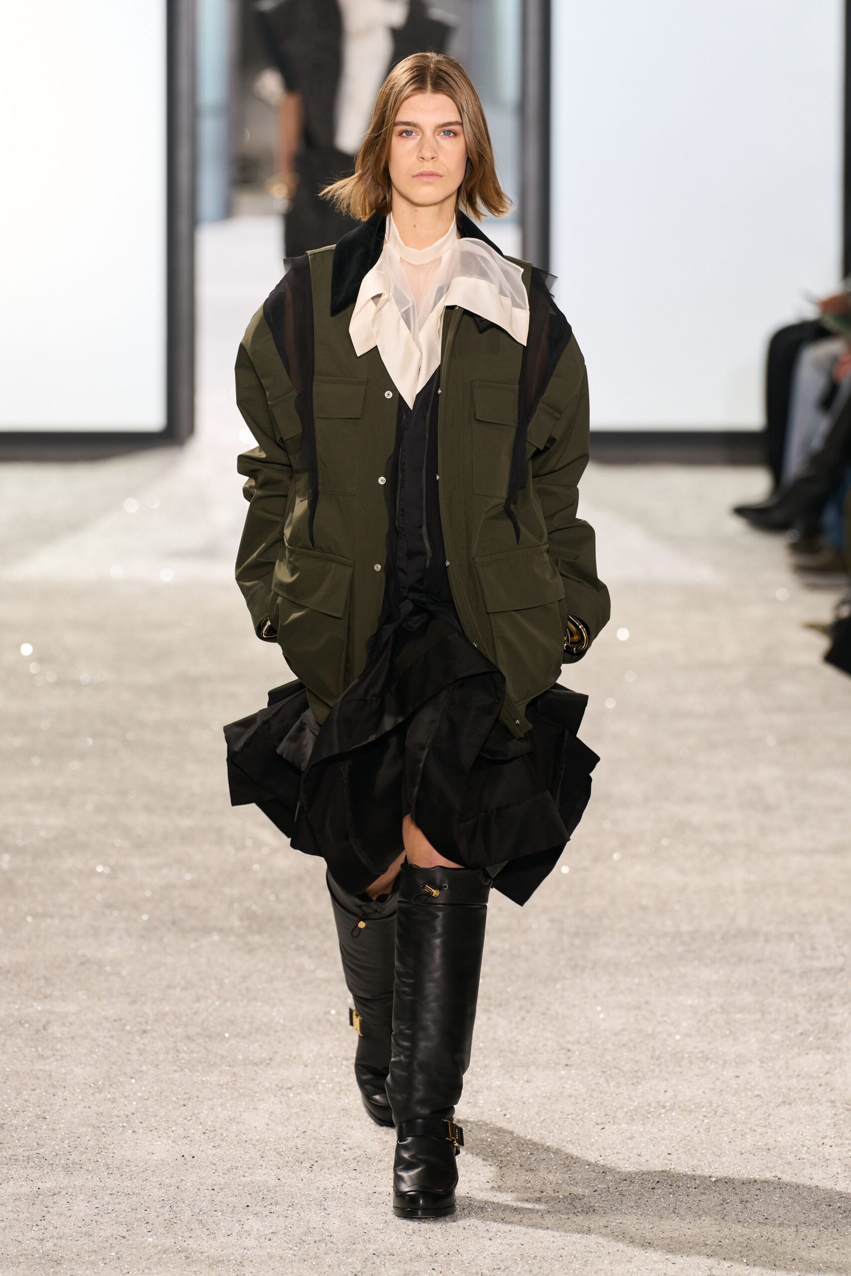 green jacket white blouse black skirt