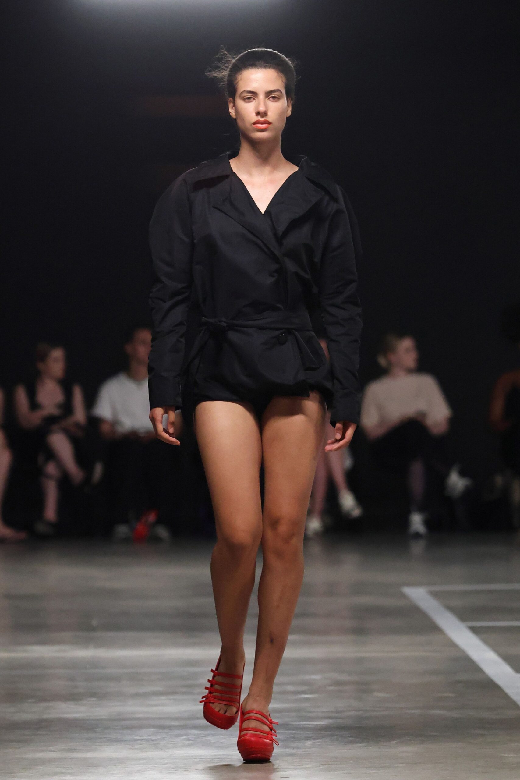 black fitted jumpsuit with red shoes