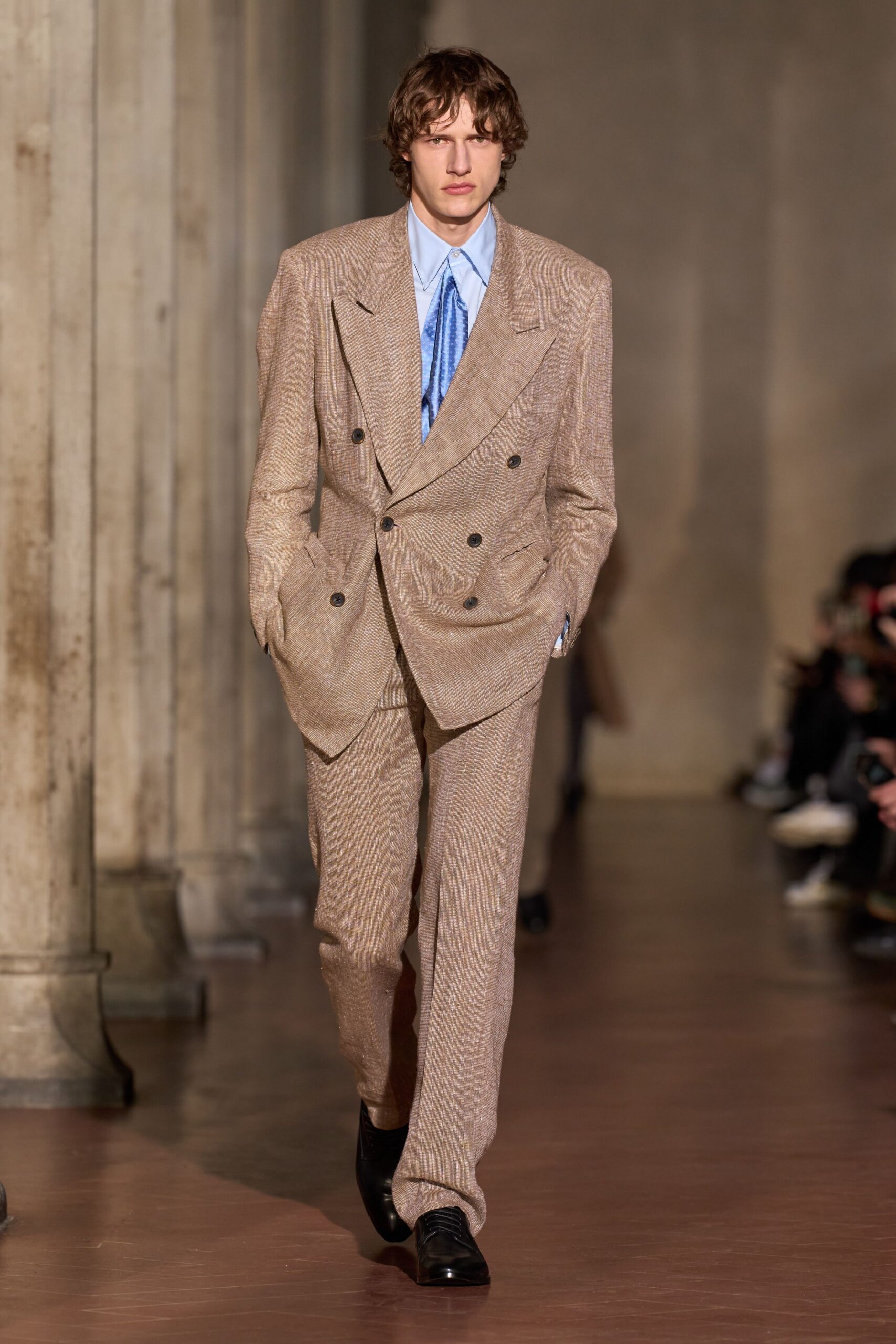 beige tailored suit with blue shirt