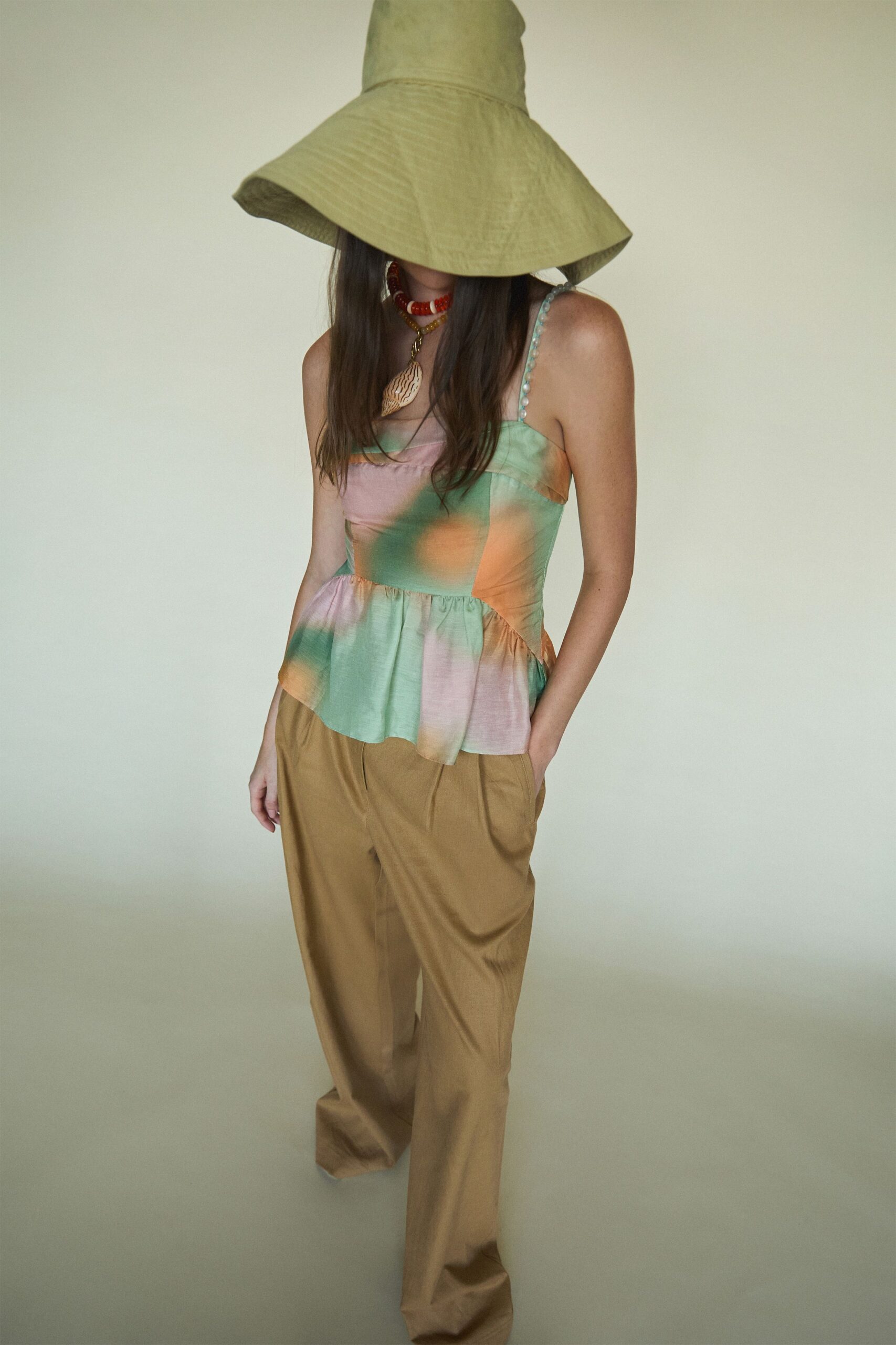 green silk sleeveless fitted pleated top