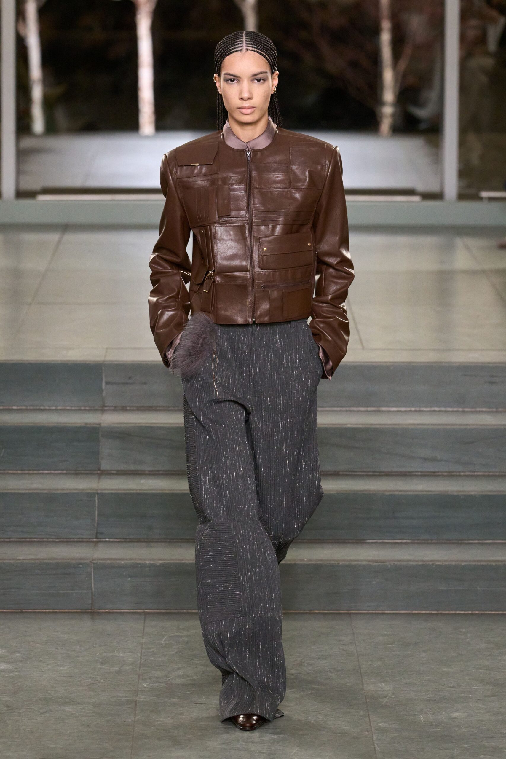brown leather fitted jacket with gray wide-leg pants