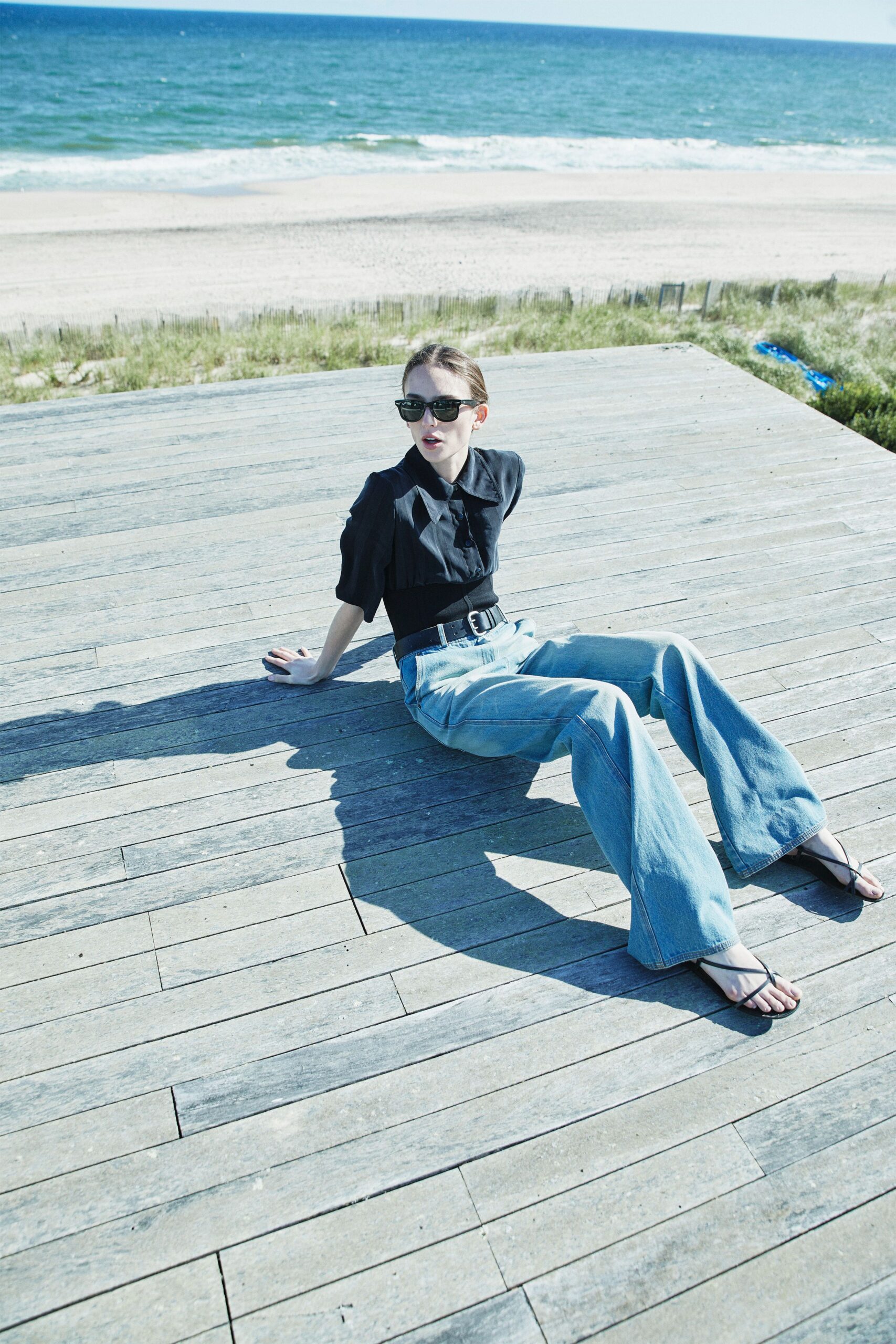 black shirt and blue wide-leg pants