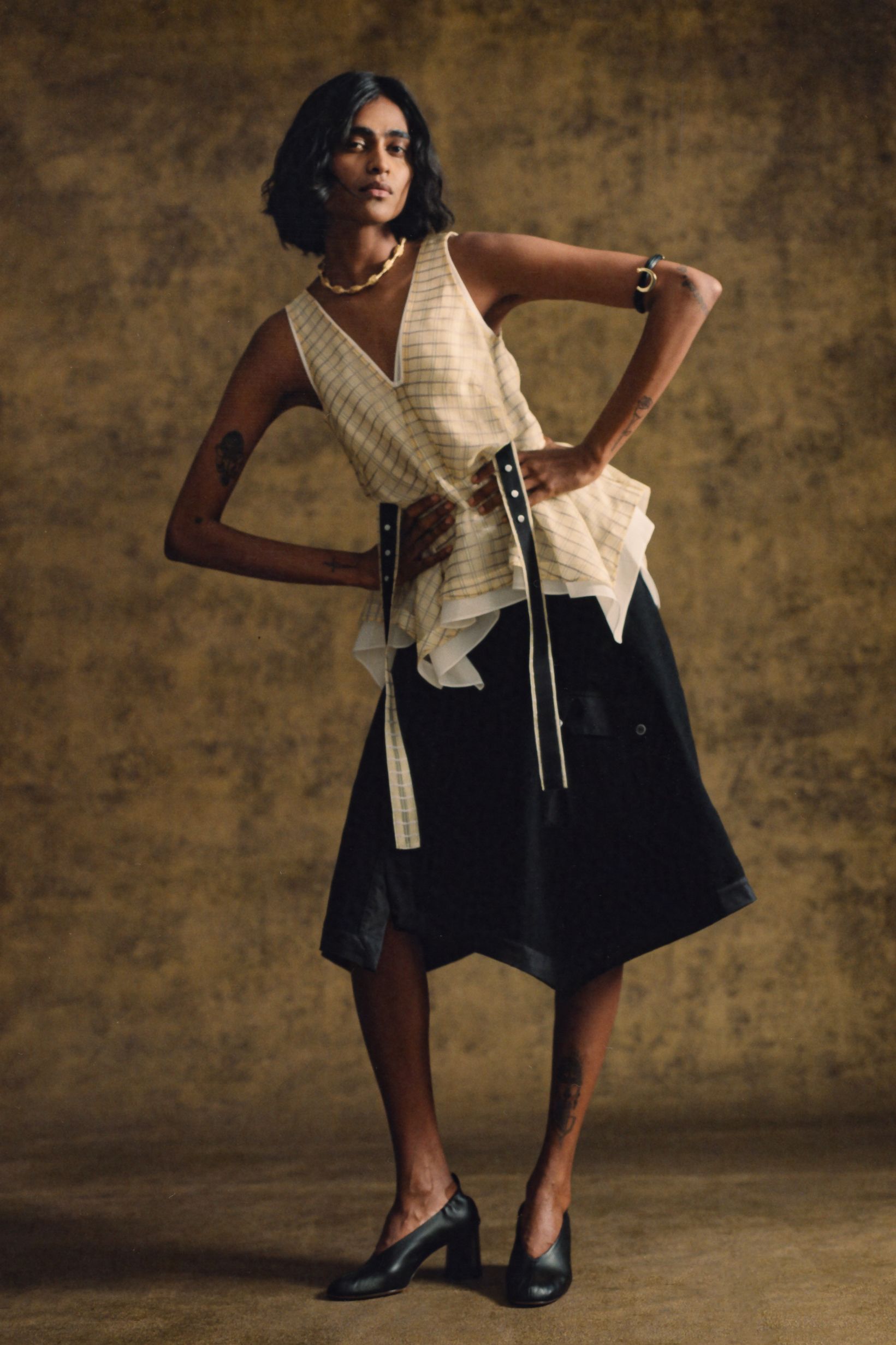 beige top black asymmetric skirt