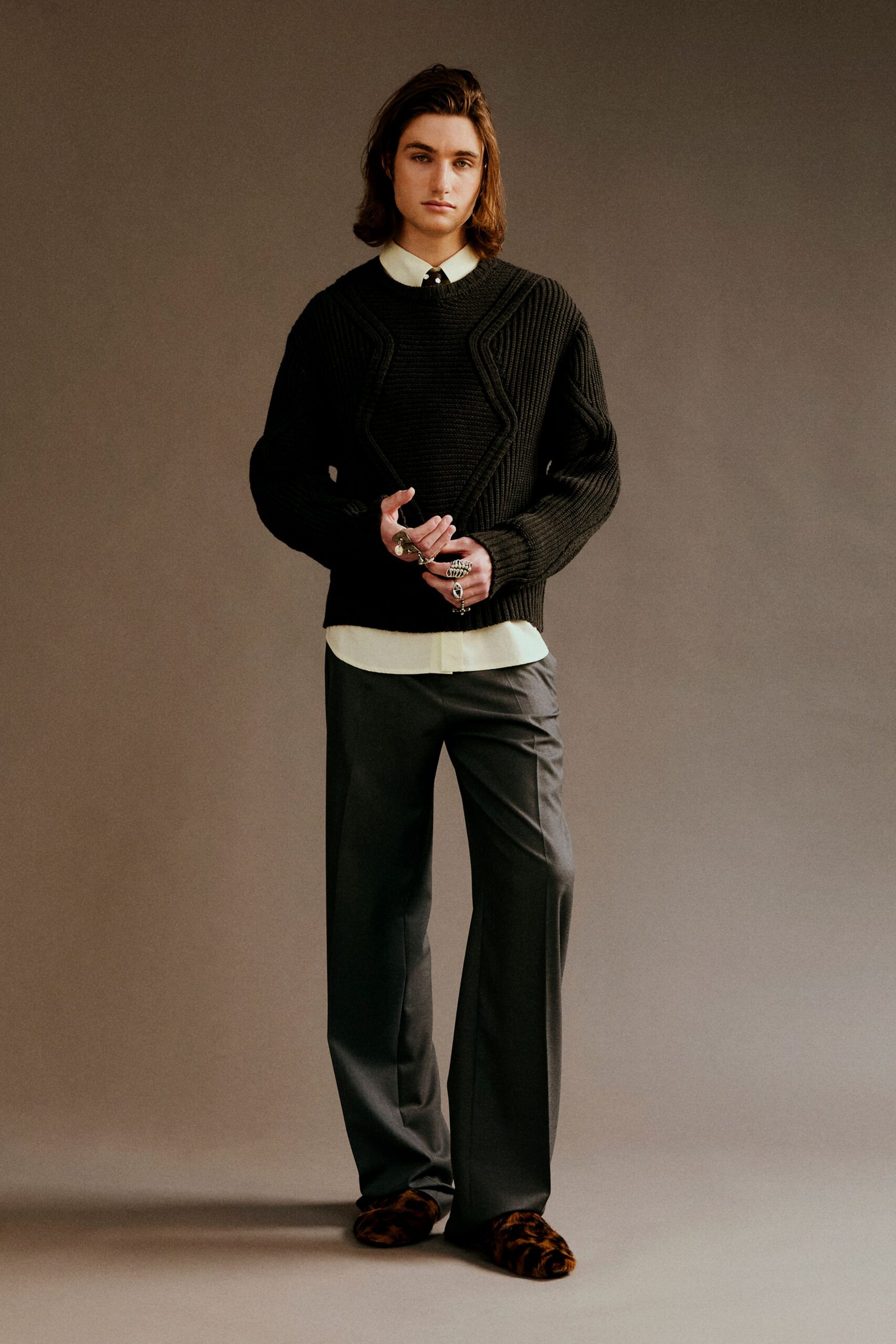 black sweater white shirt gray pants