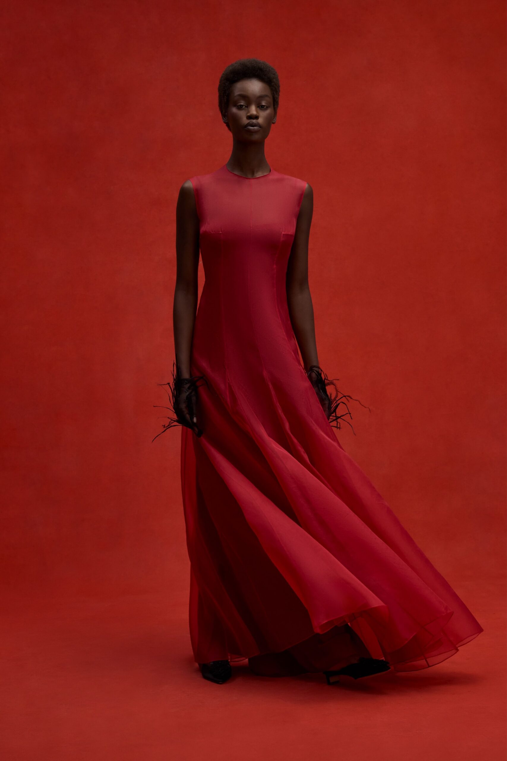red chiffon sleeveless high-neck fitted flowing sheer gown