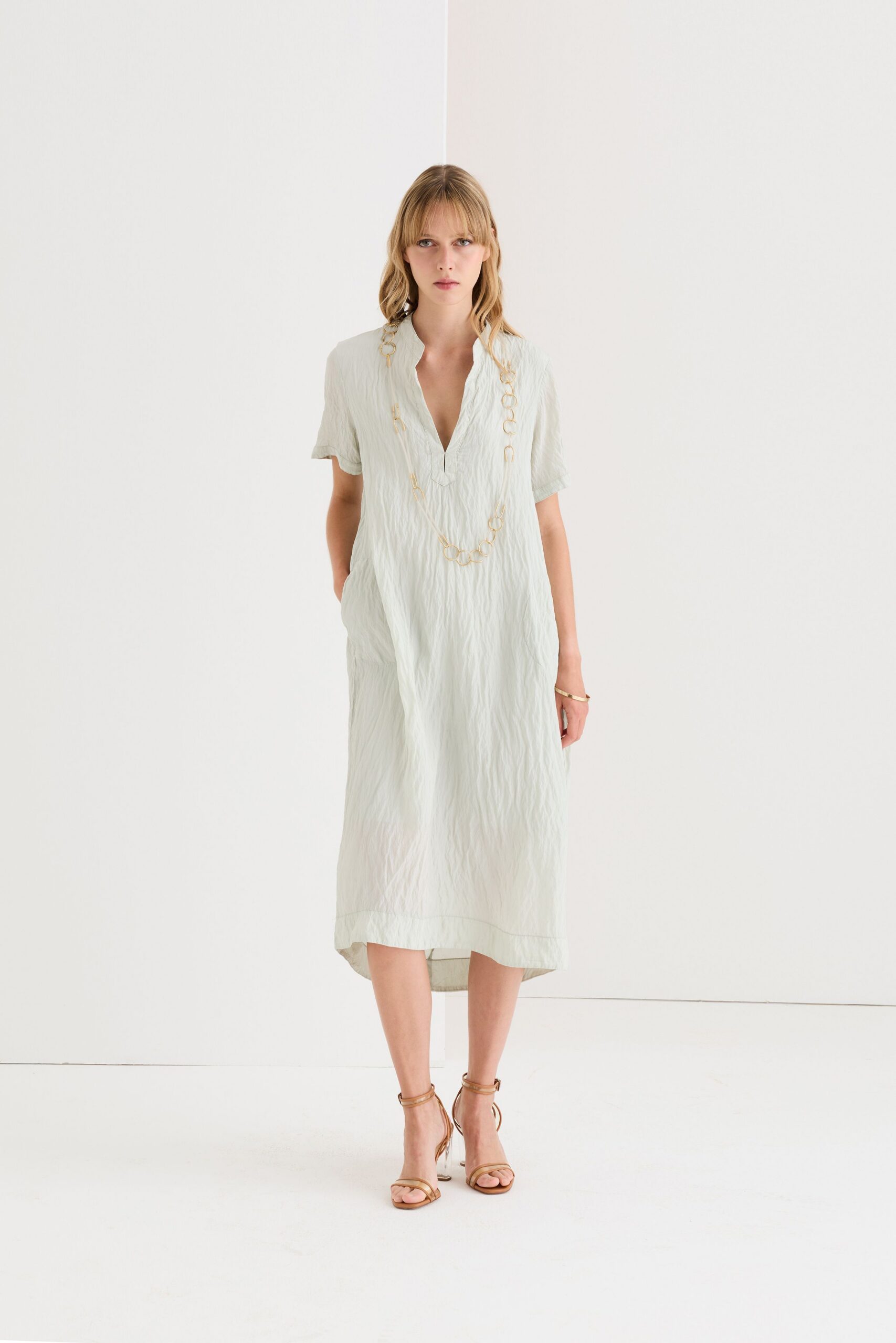 green cotton short-sleeve v-neck relaxed pleated midi dress