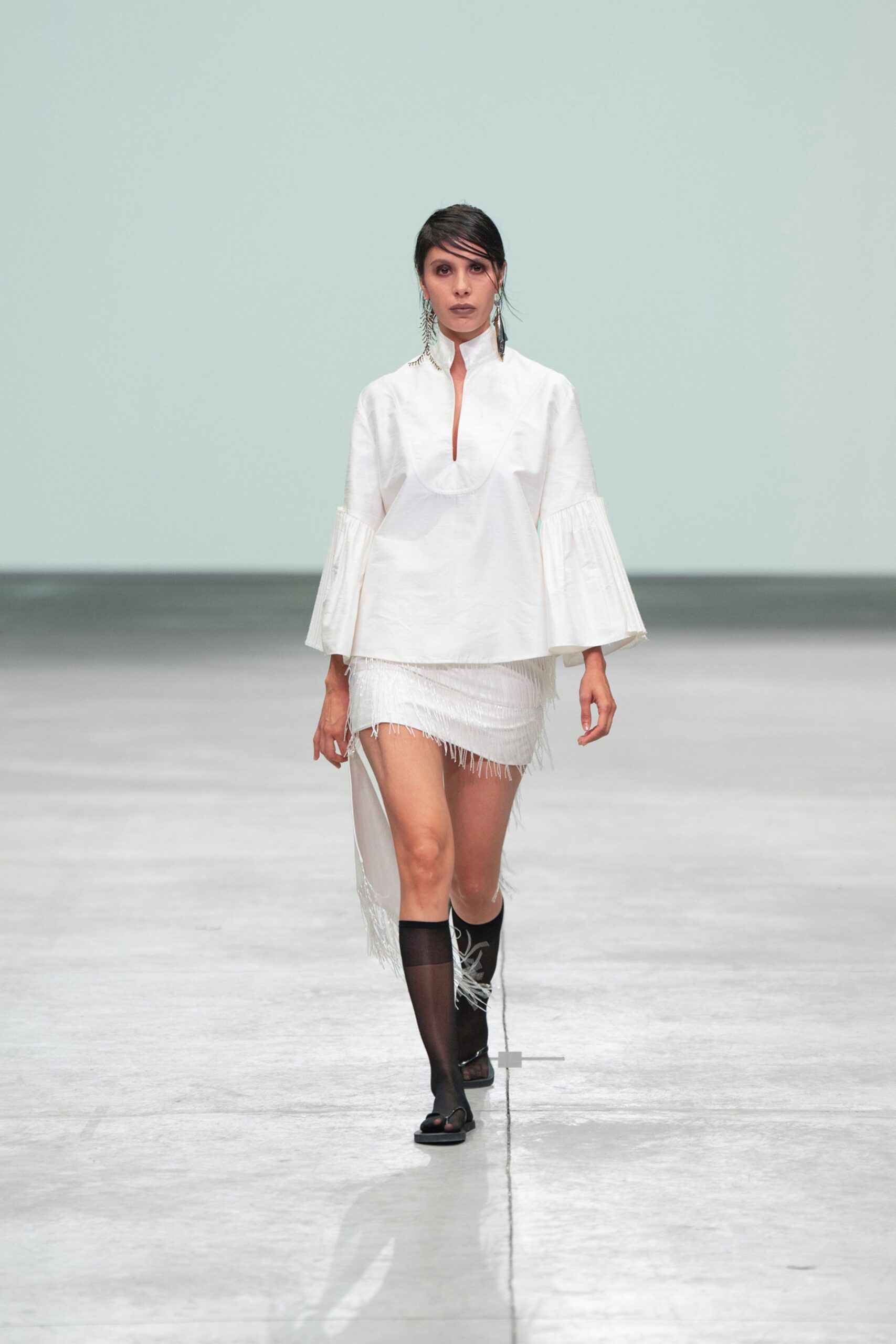 white relaxed top with fringed mini skirt