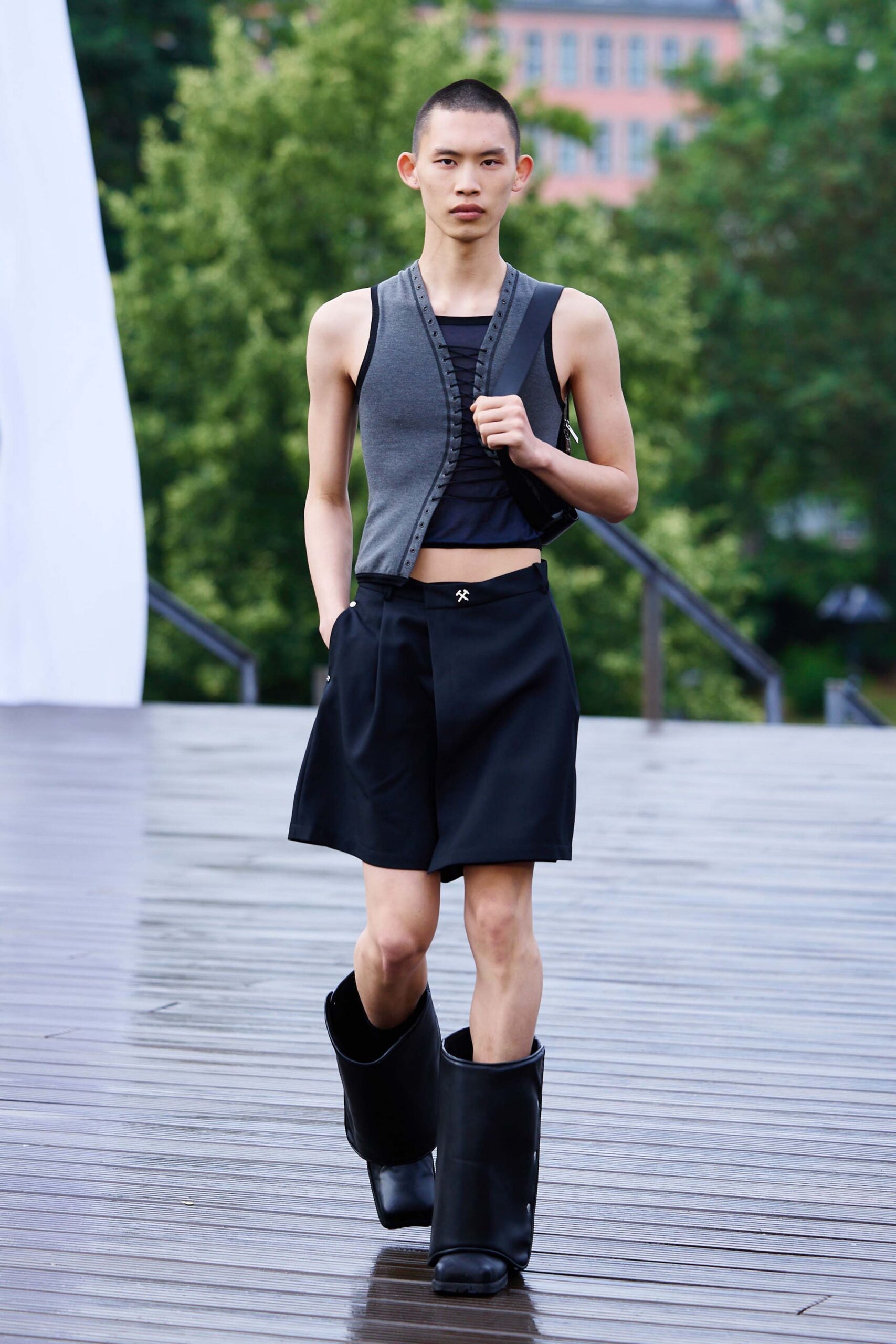 gray vest black top and shorts