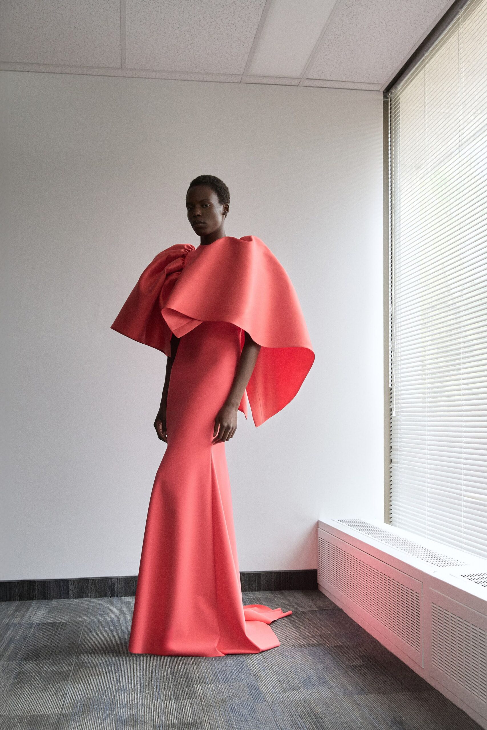 red neoprene sleeveless structured layered cape