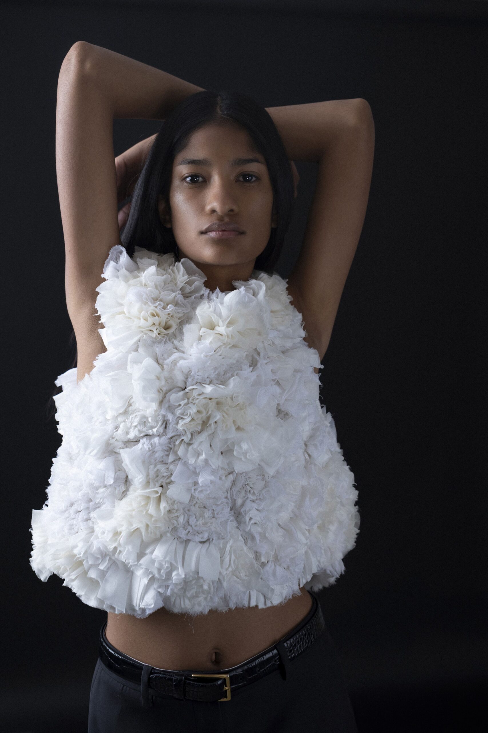 white ruffled top with black pants