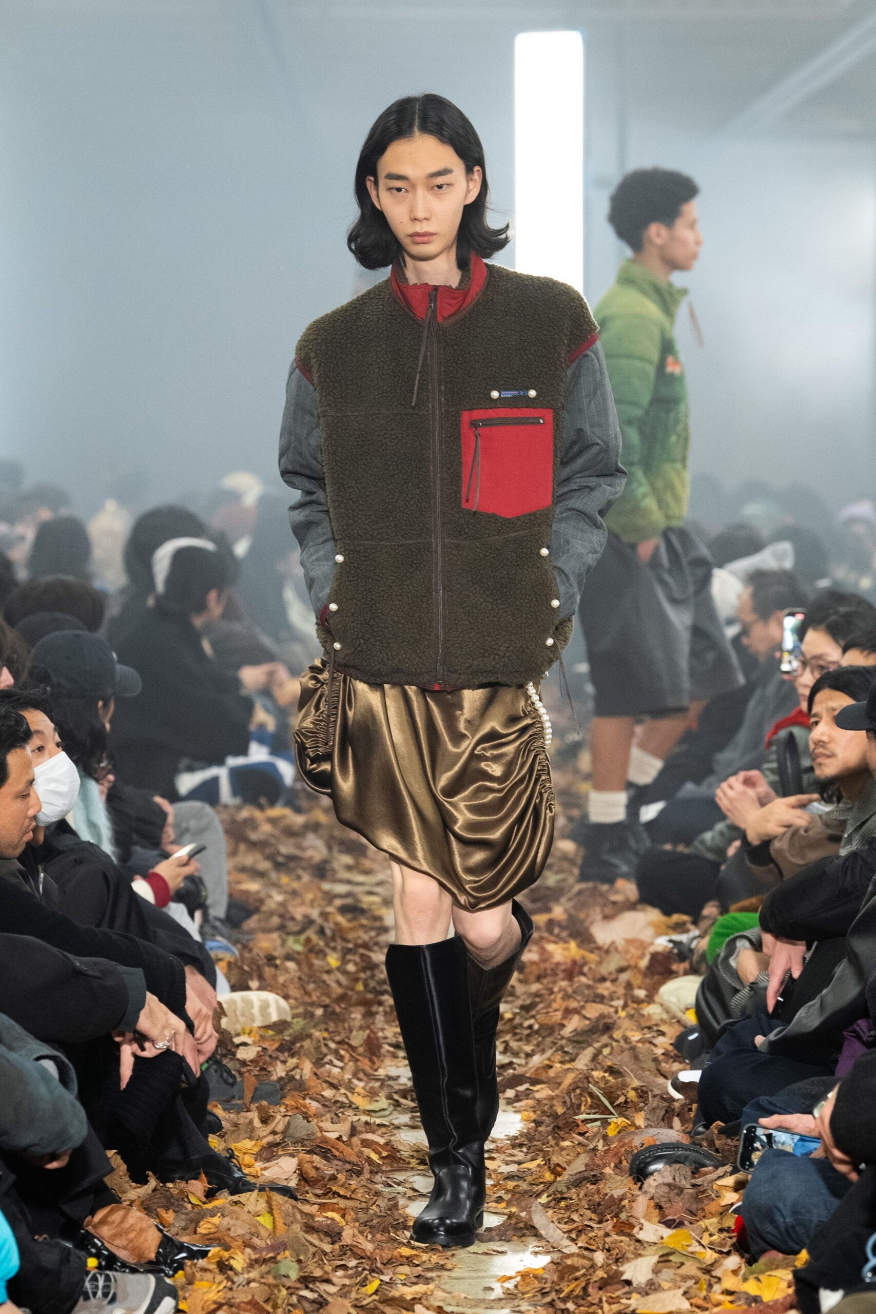 green jacket with brown top and gold skirt