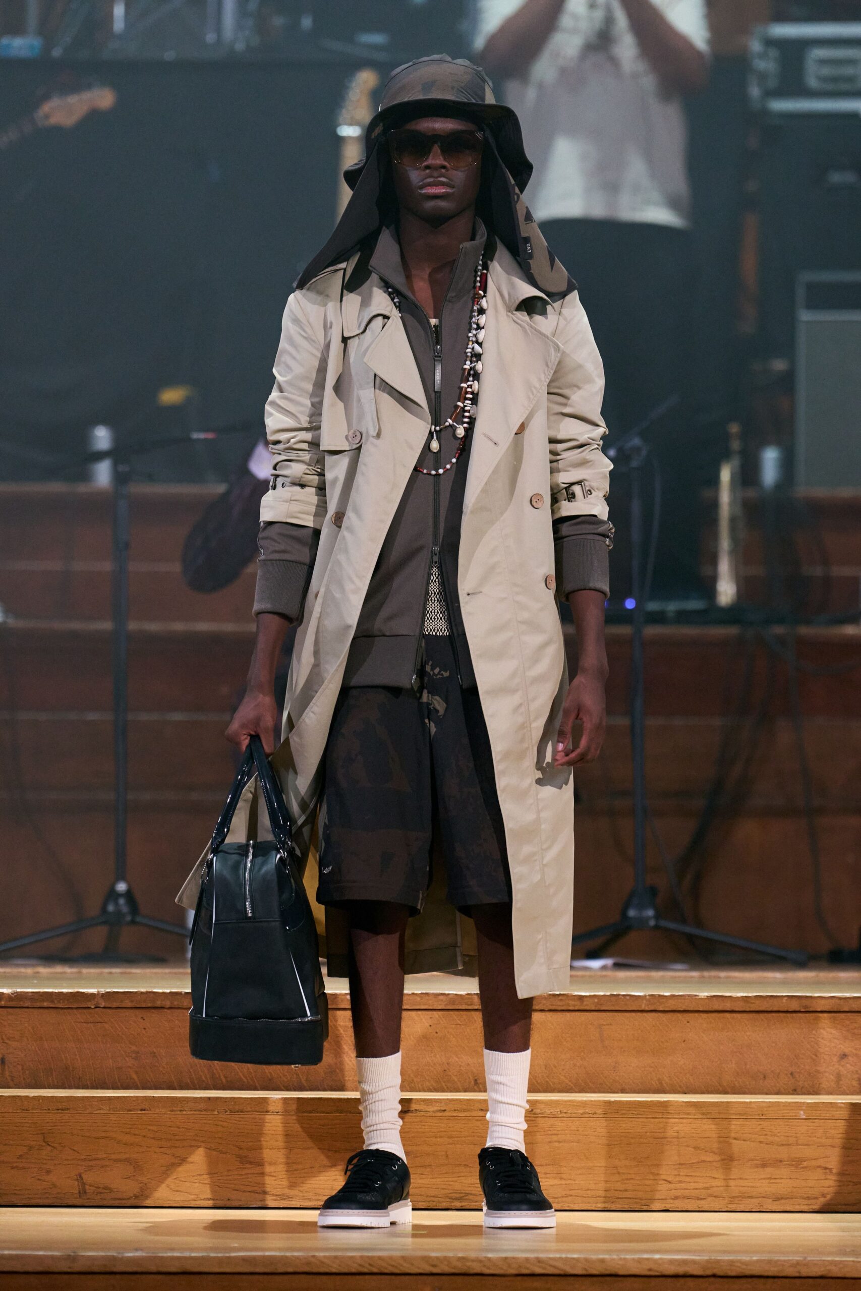 beige trench coat with black accessories