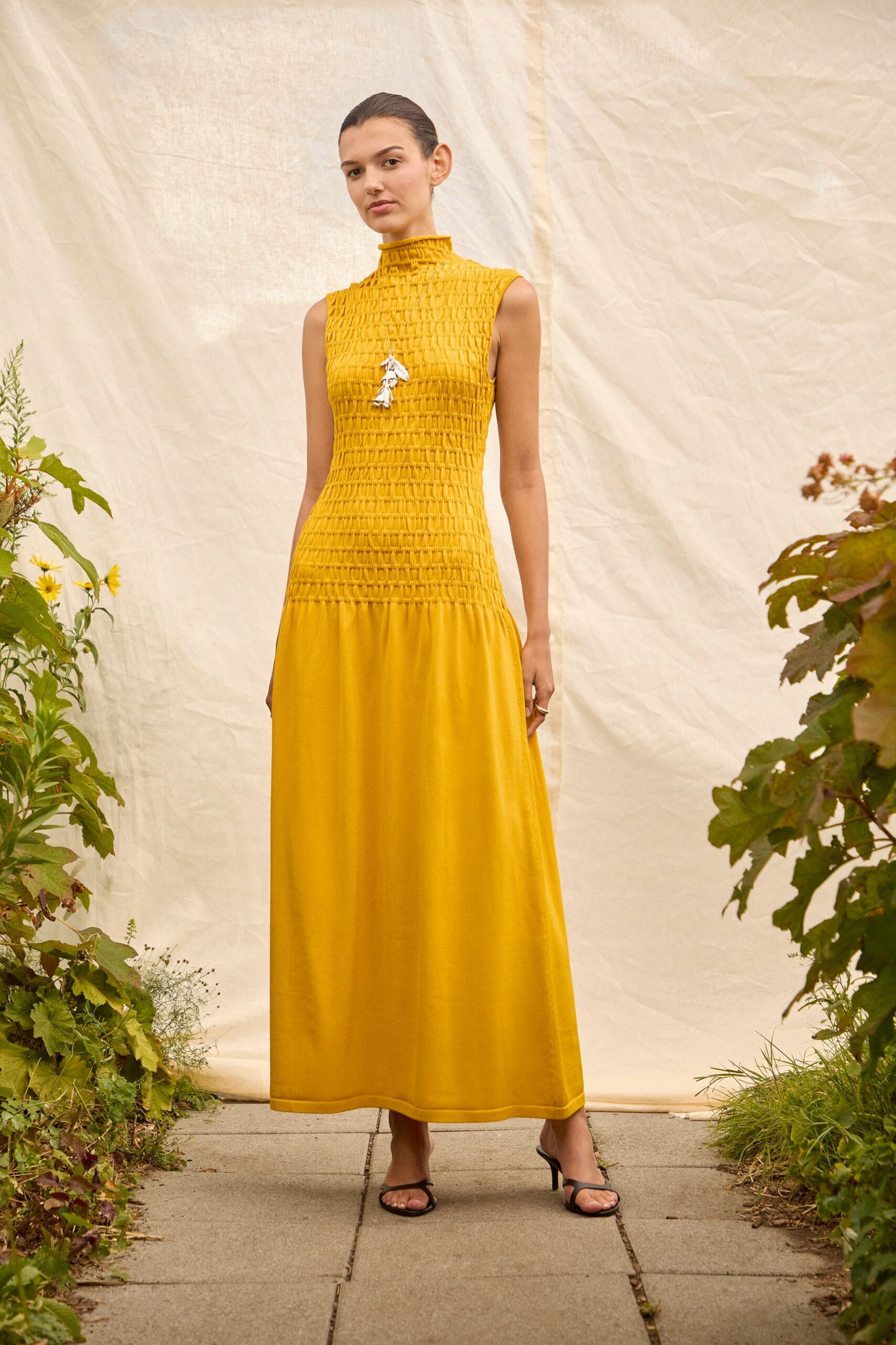 yellow cotton sleeveless high-neck fitted ruched tiered gown