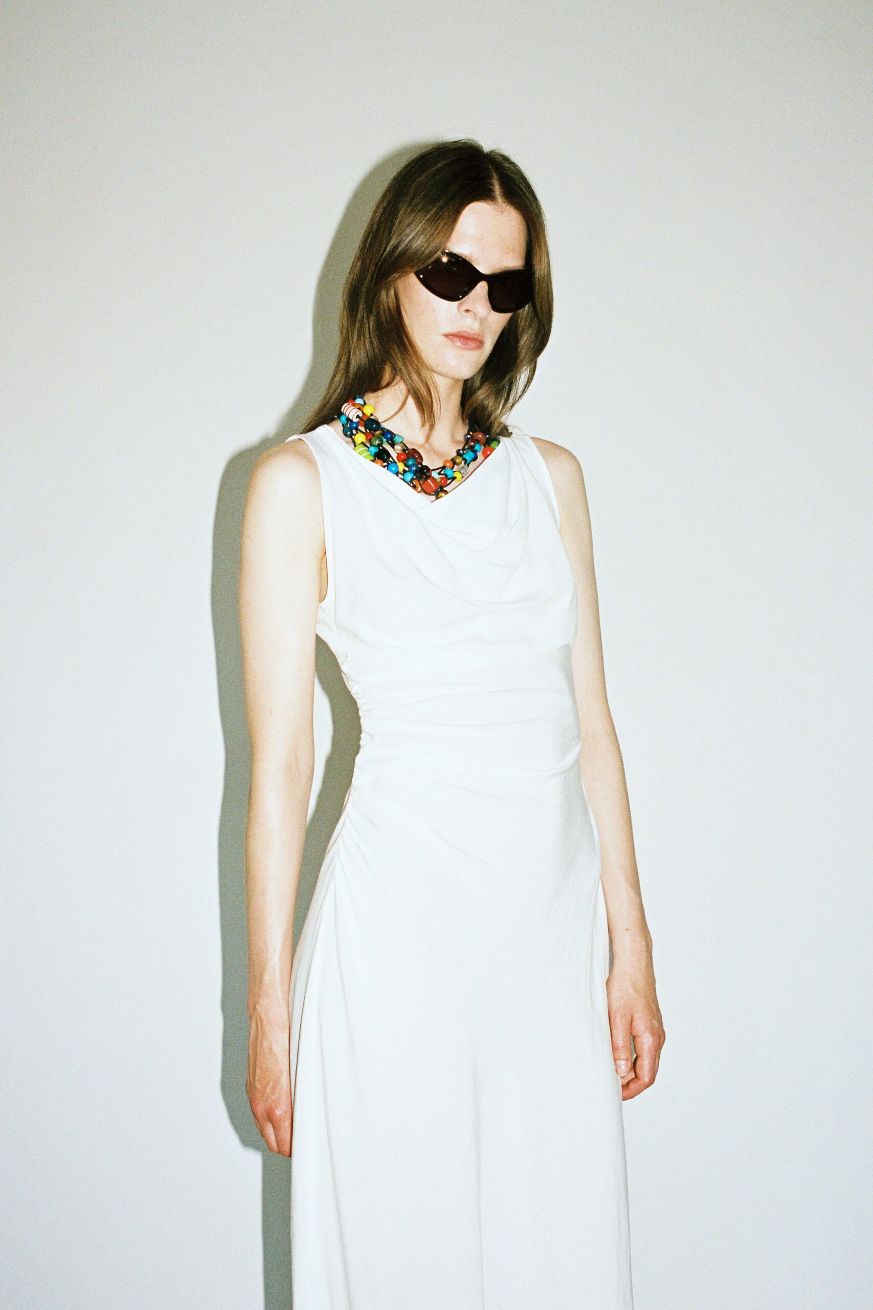 fitted white maxi dress with sunglasses