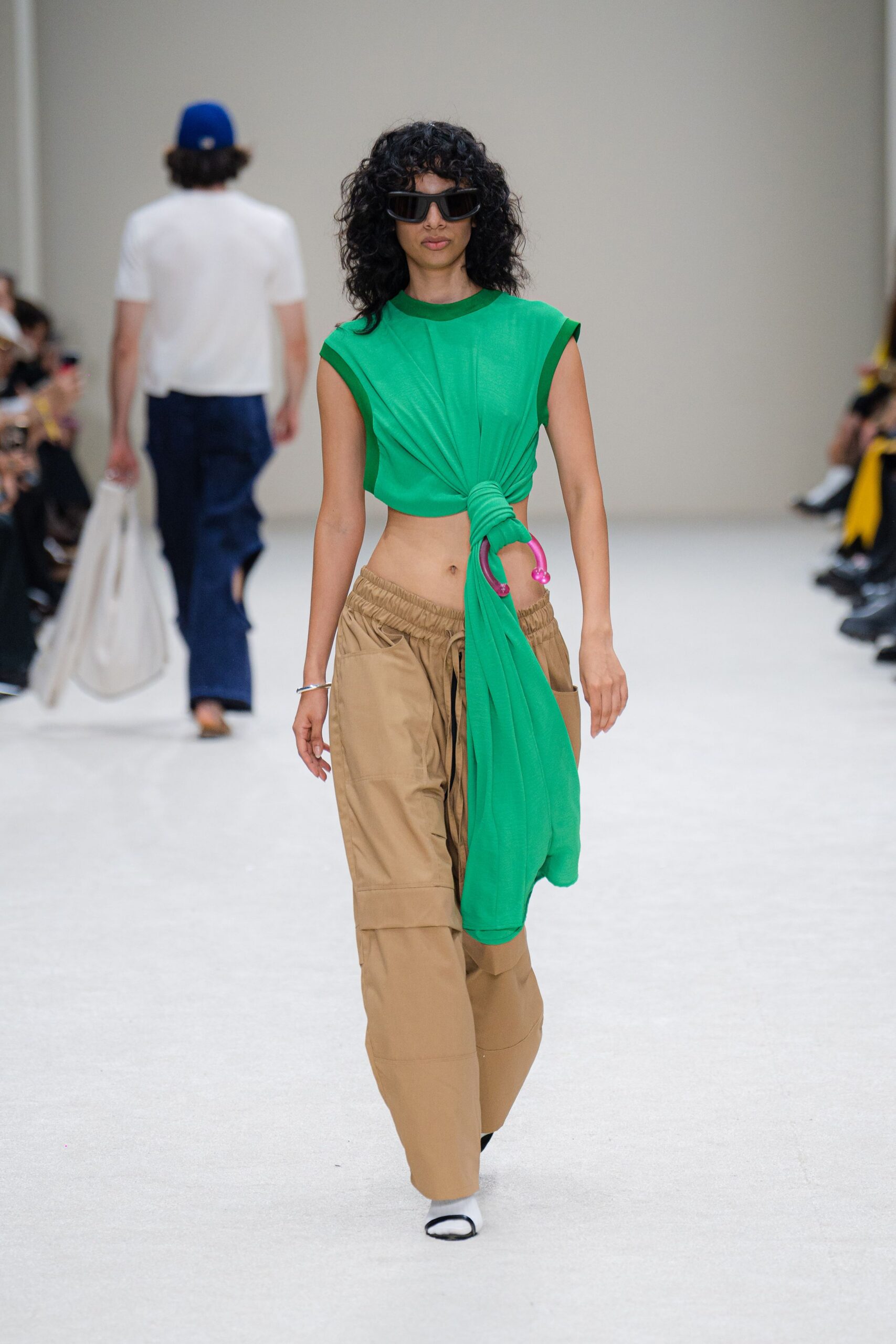 green fitted top with beige pants