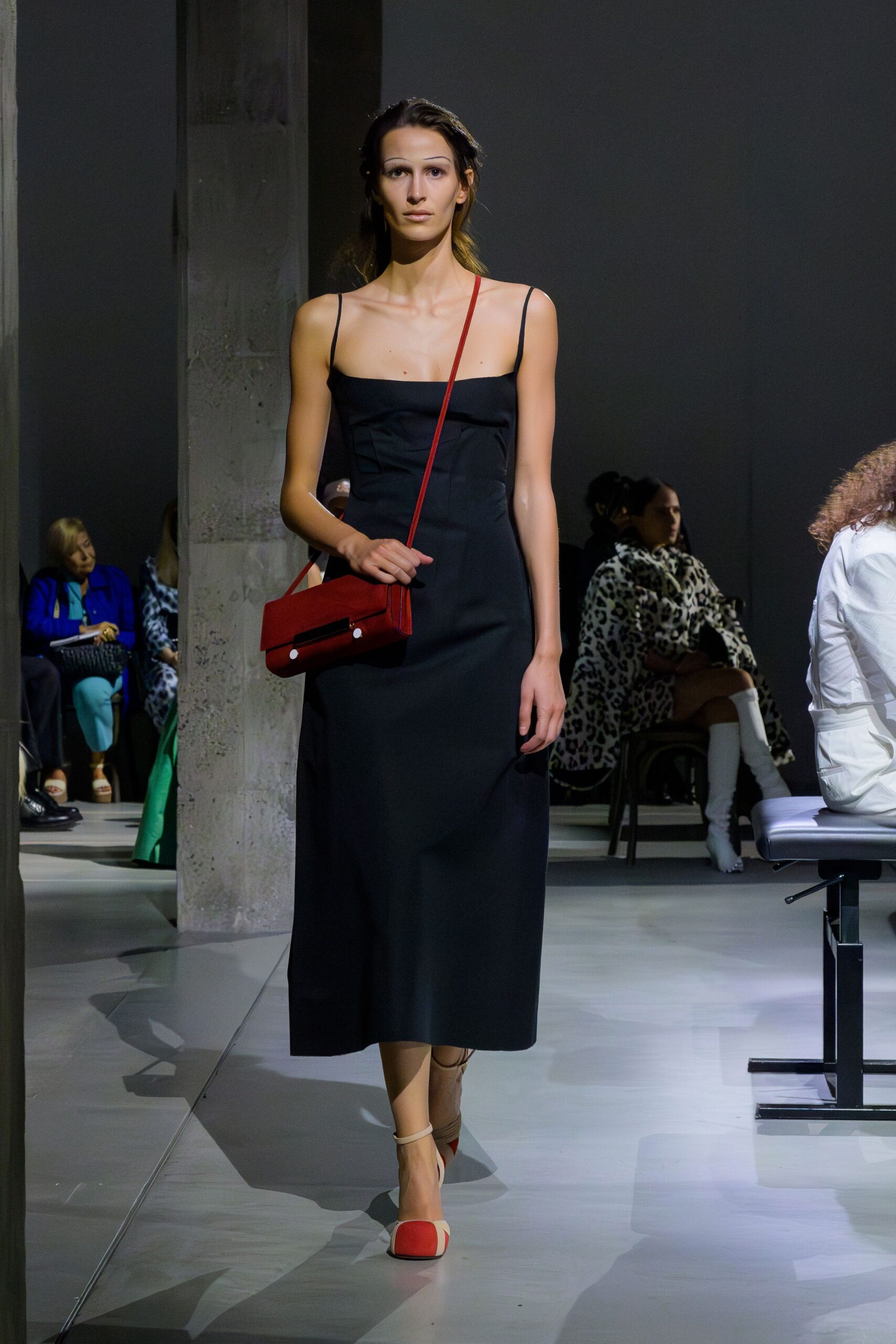 black fitted midi dress with red accessories
