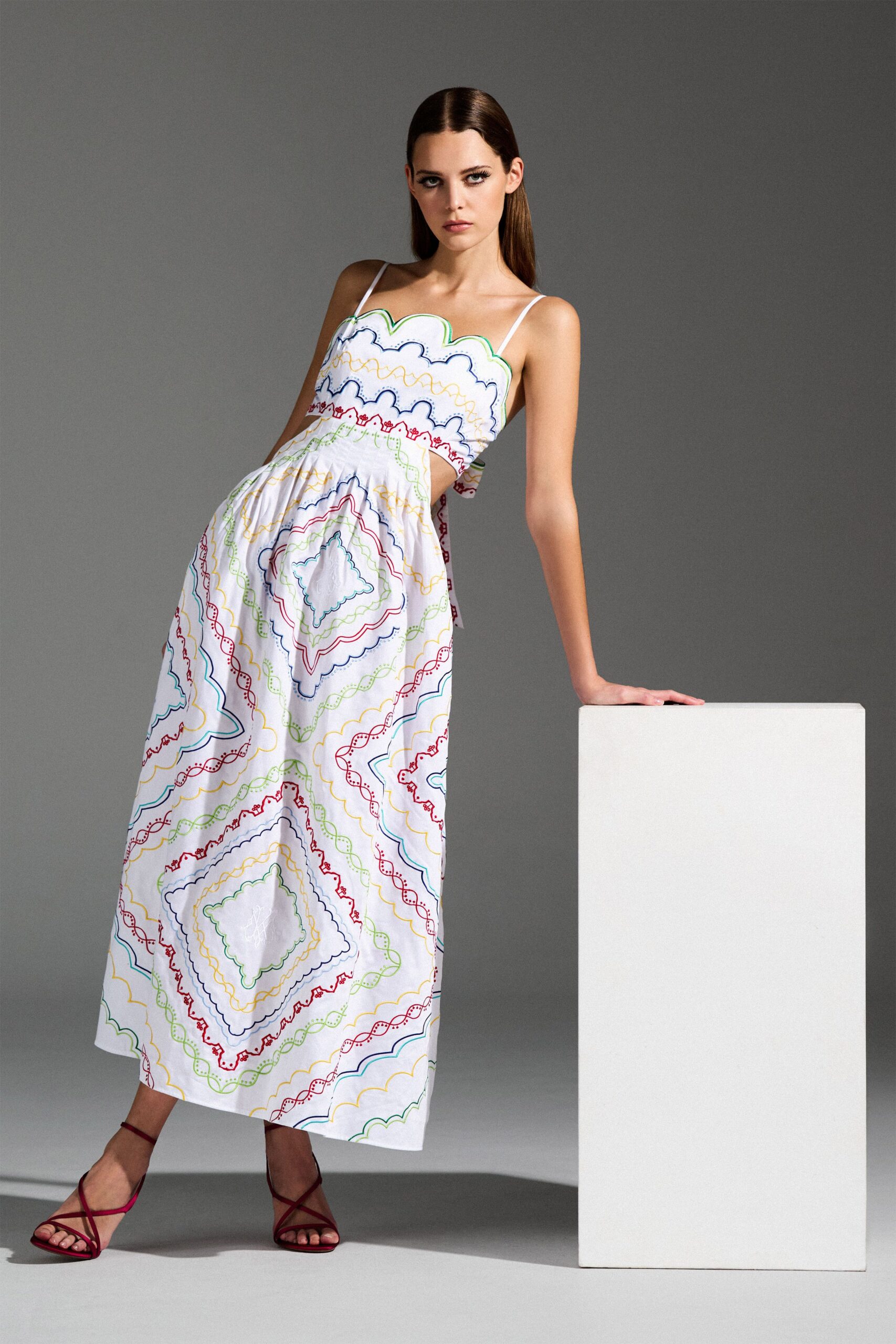 white cotton sleeveless v-neck fitted pleated embroidered dress