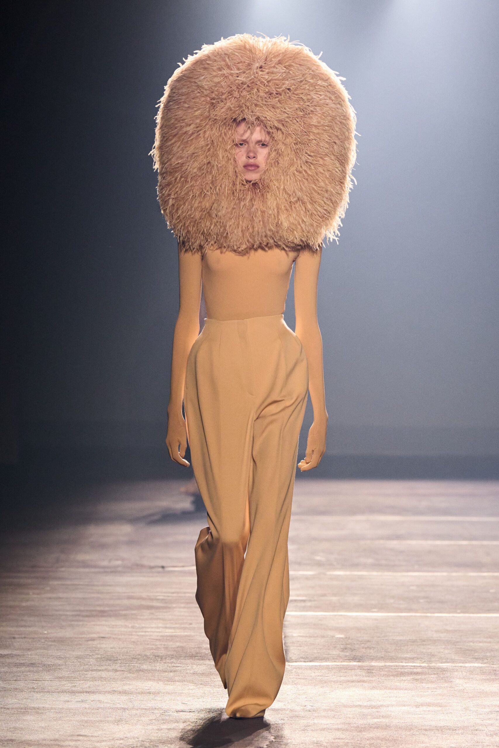 beige fitted top and pants with fur hat