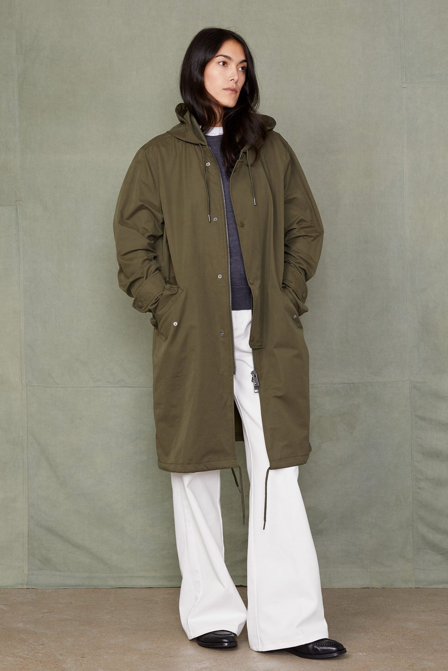 green coat gray top white pants