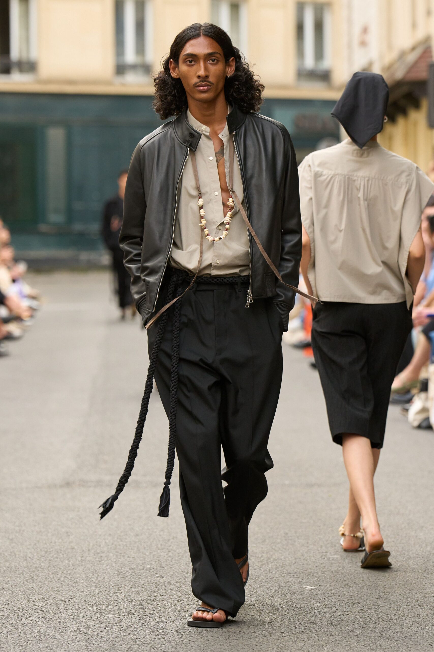 black leather jacket beige shirt black pants