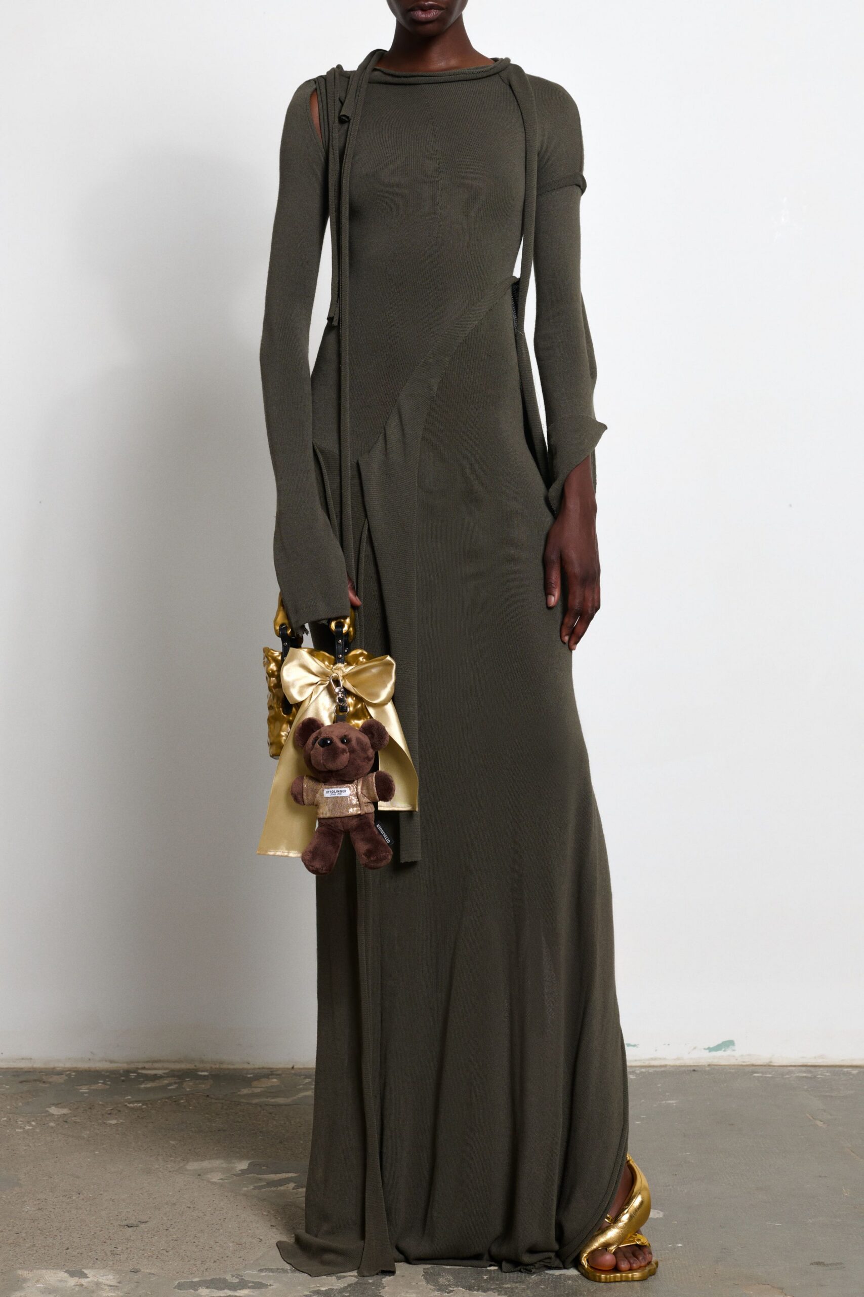 green fitted gown with gold accessories