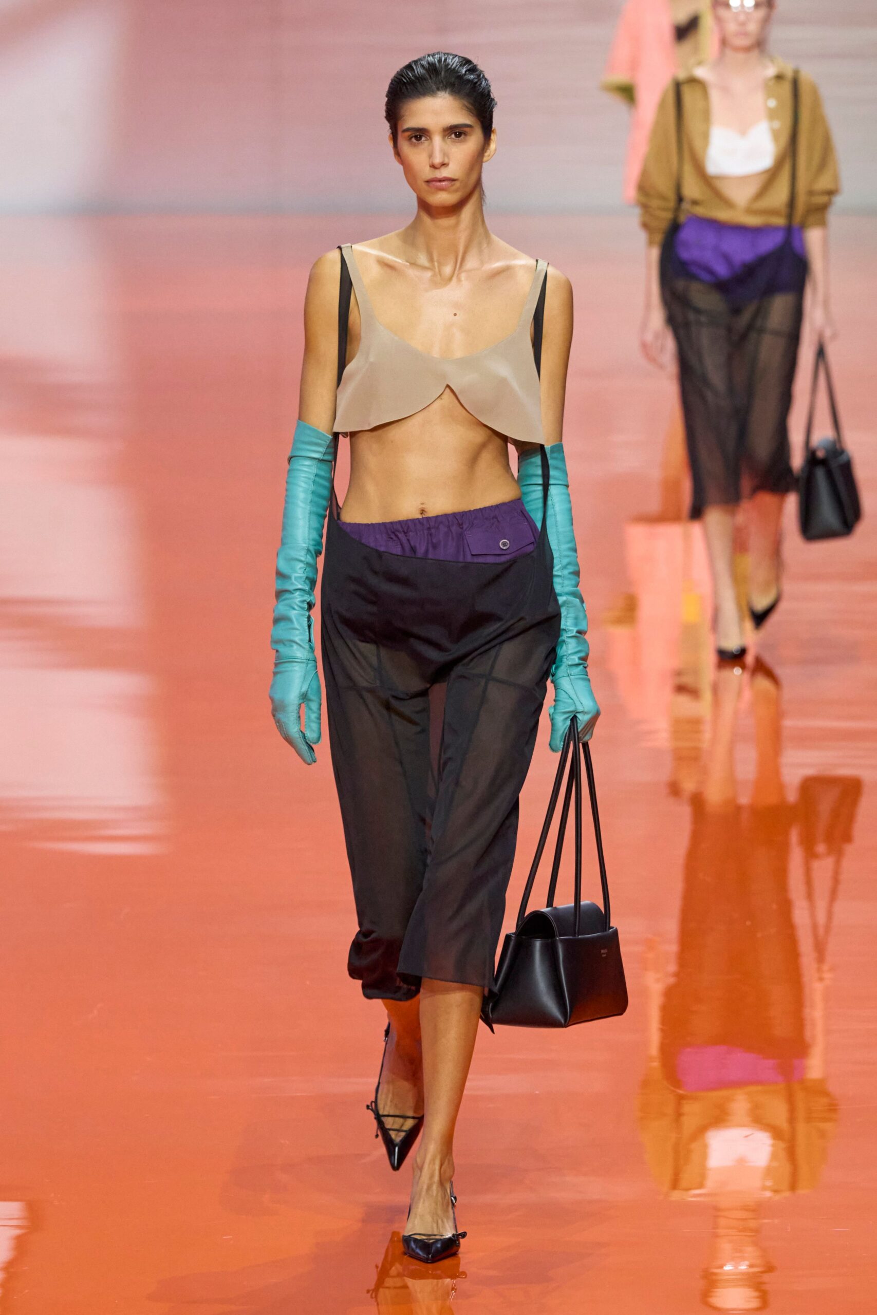 beige silk sleeveless top with black pants