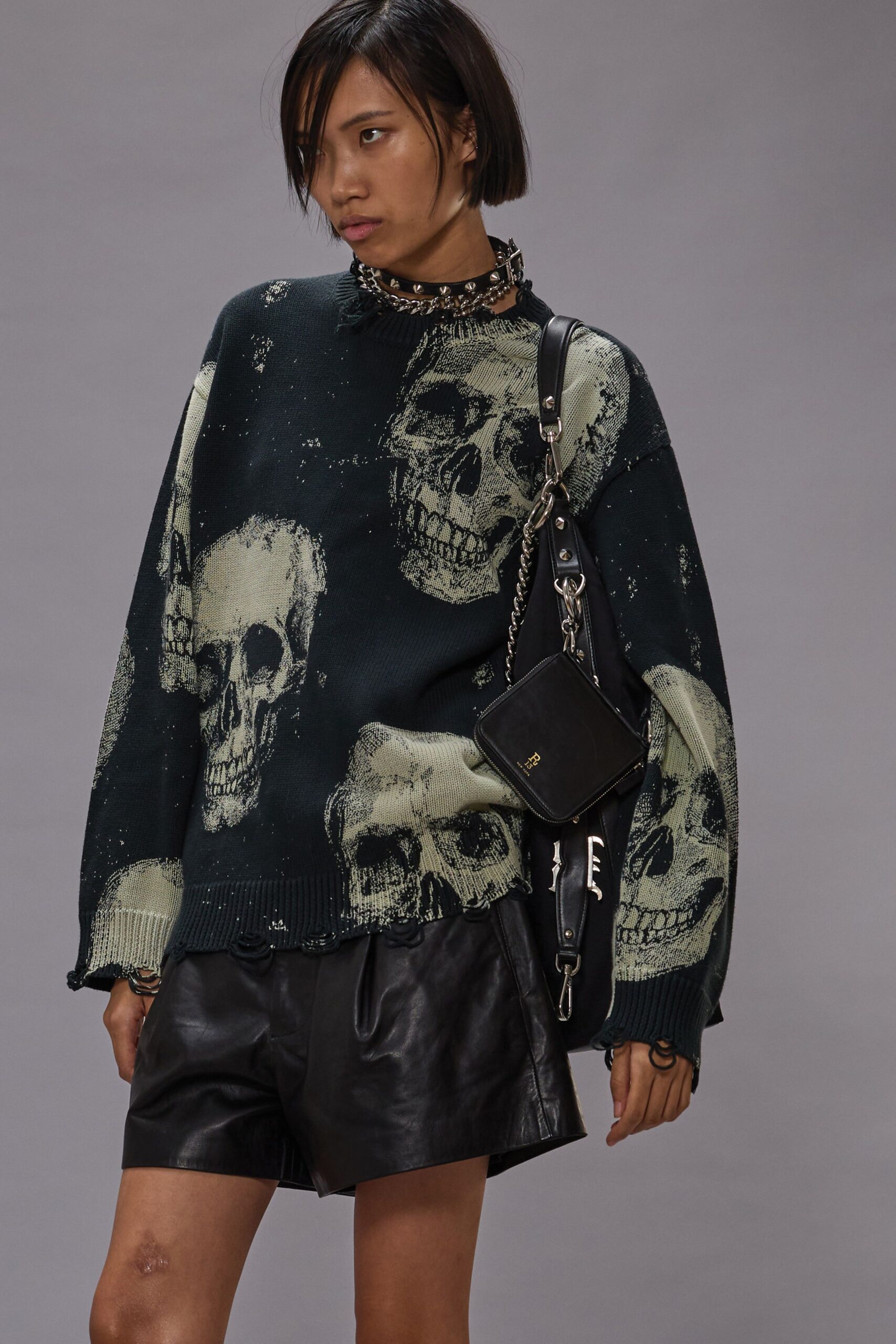 black skull print sweater with leather shorts