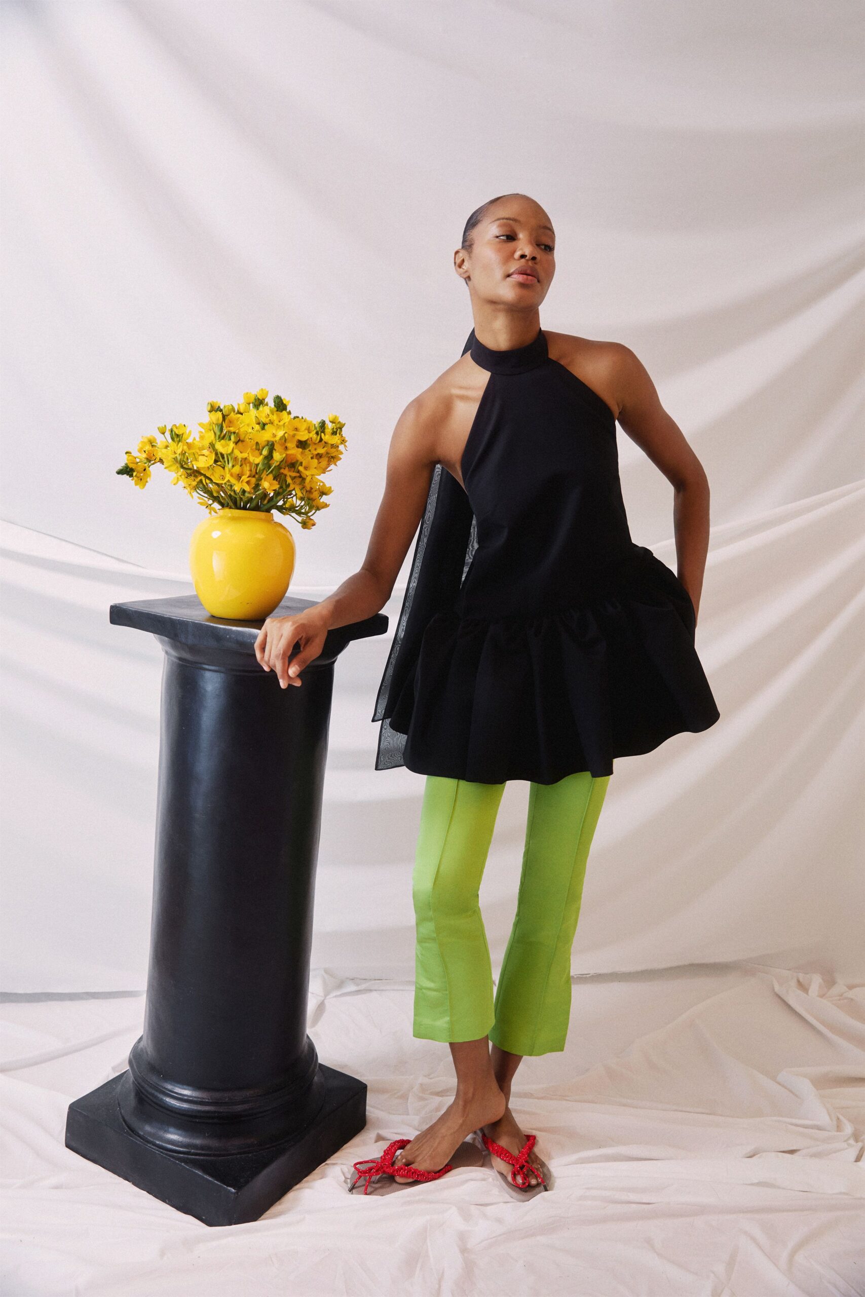 black fitted top with green pants