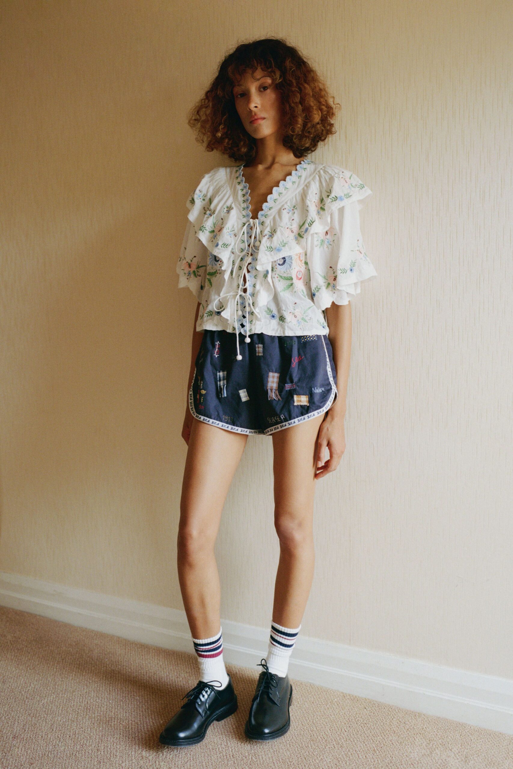 white embroidered top with denim shorts