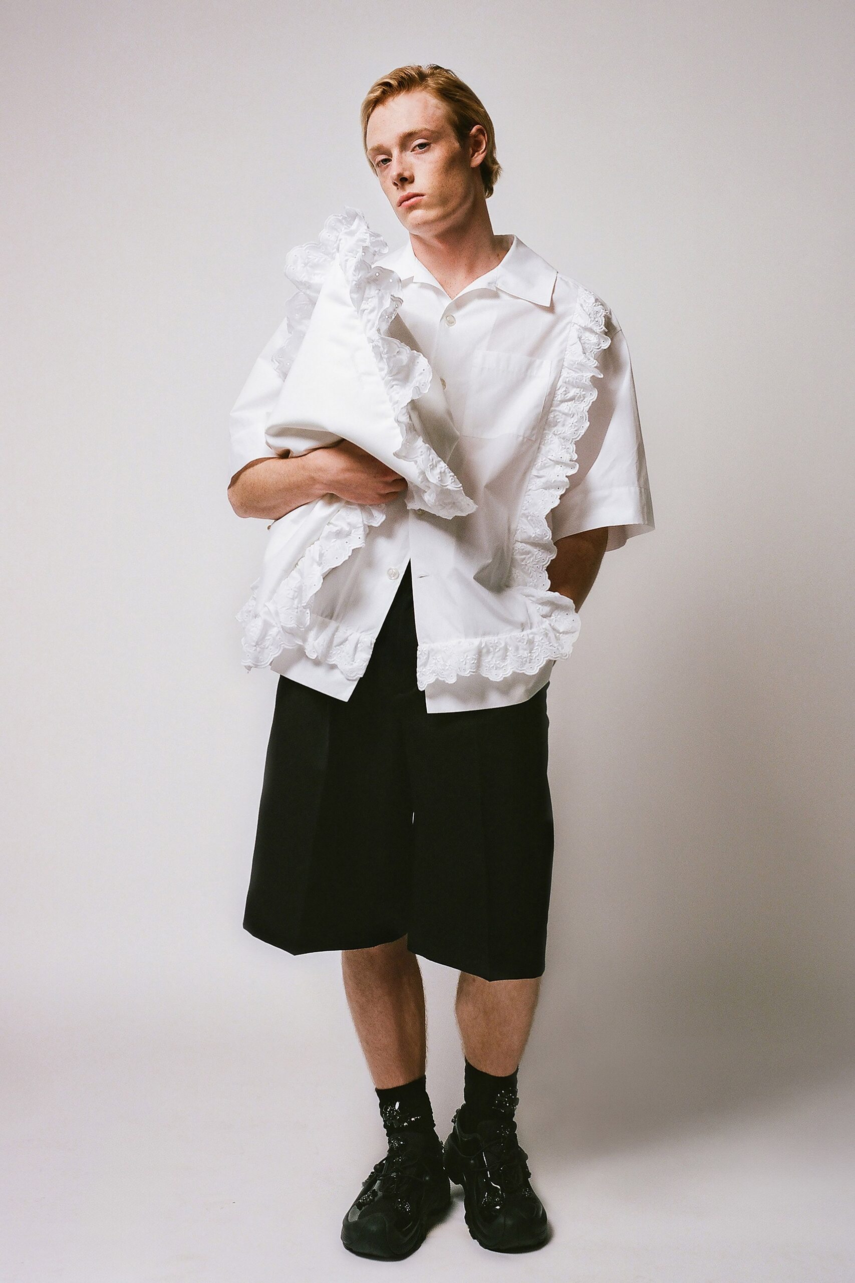 white ruffled shirt with black shorts