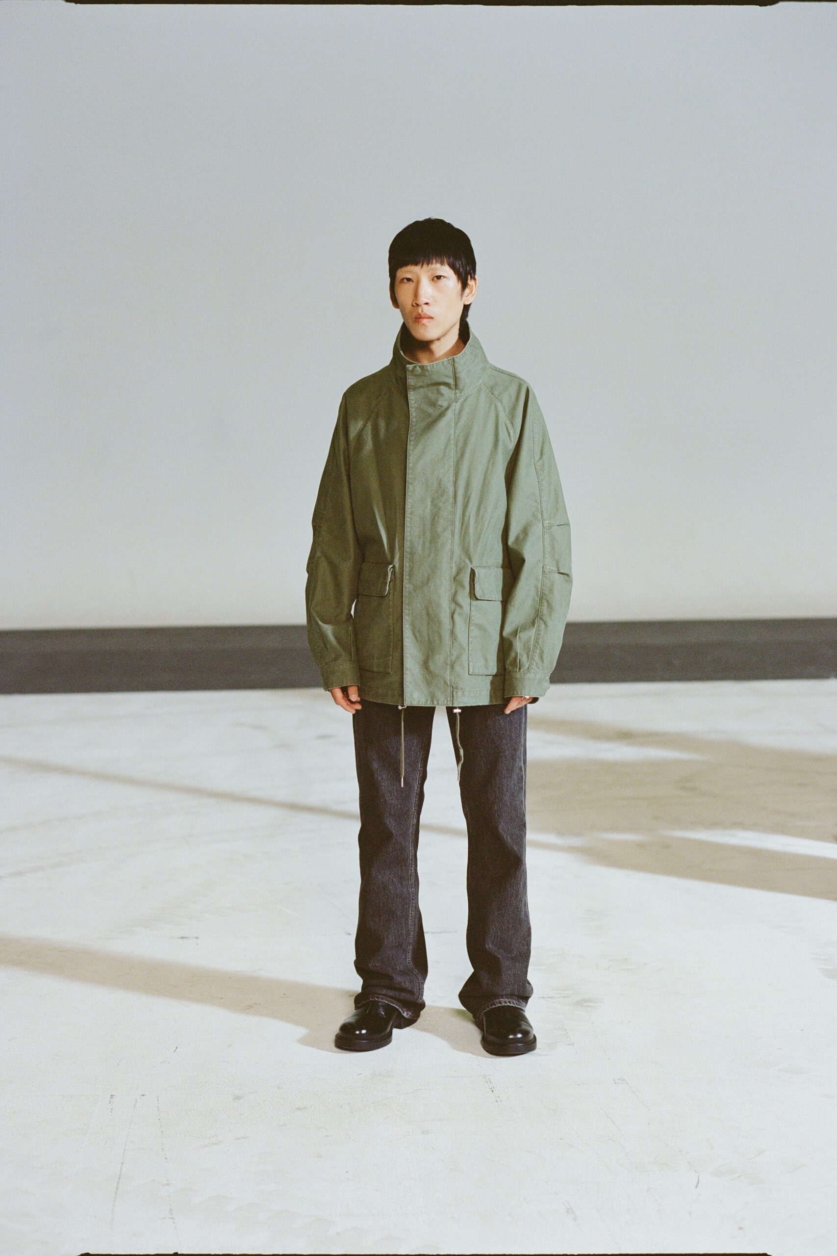 green relaxed jacket with denim pants