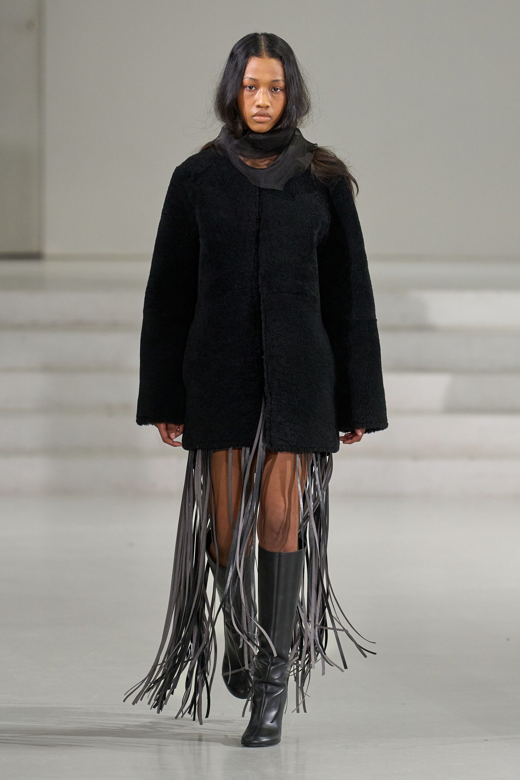 black faux-fur coat with fringes