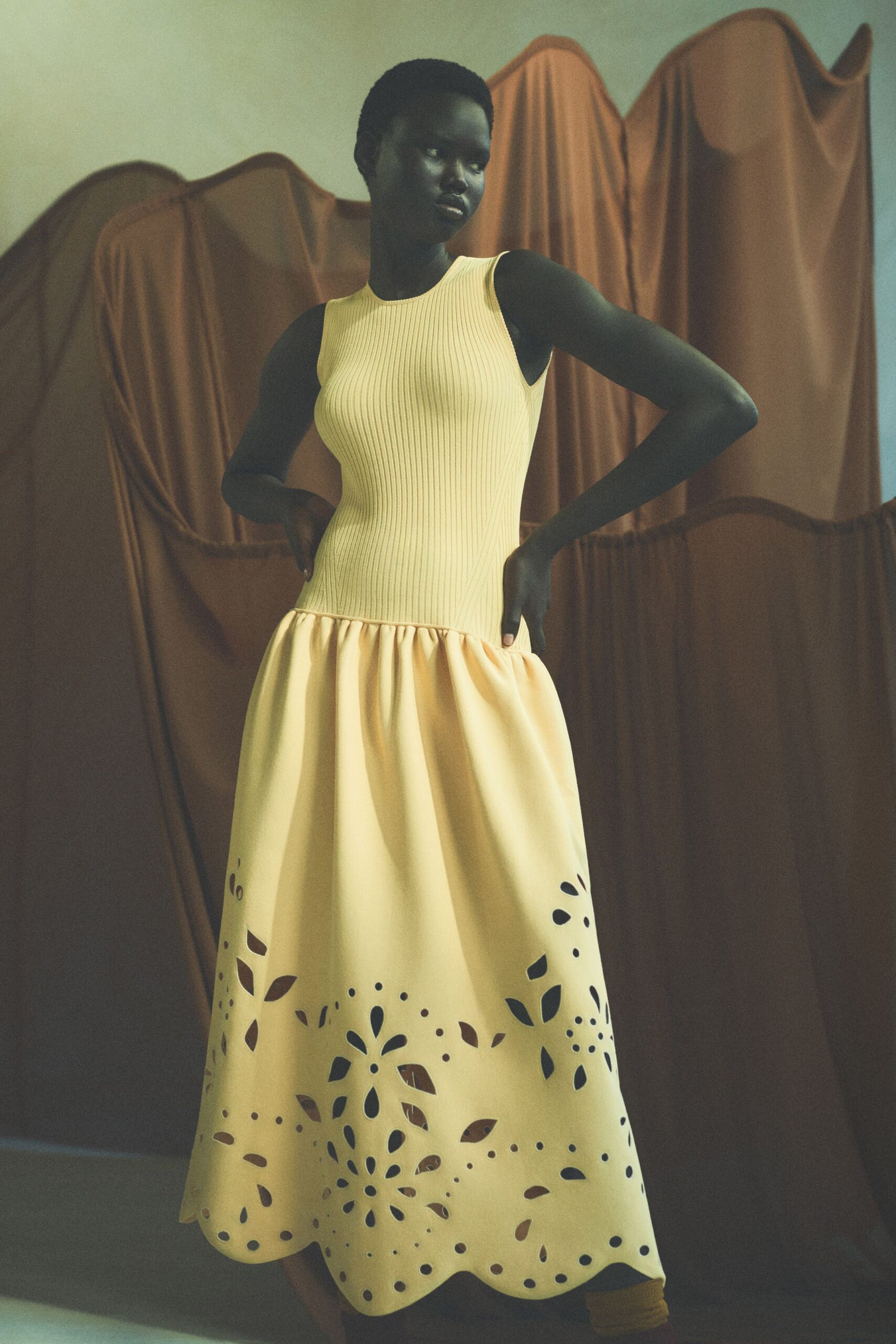 yellow sleeveless pleated dress