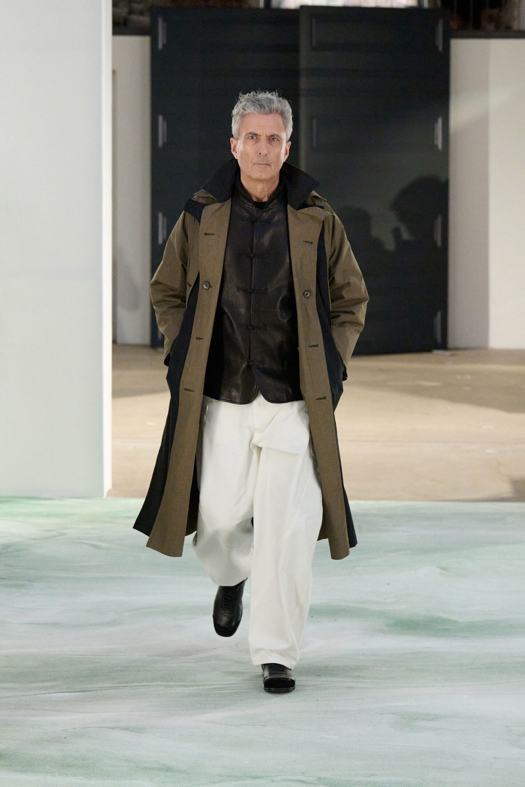 brown coat black shirt white pants