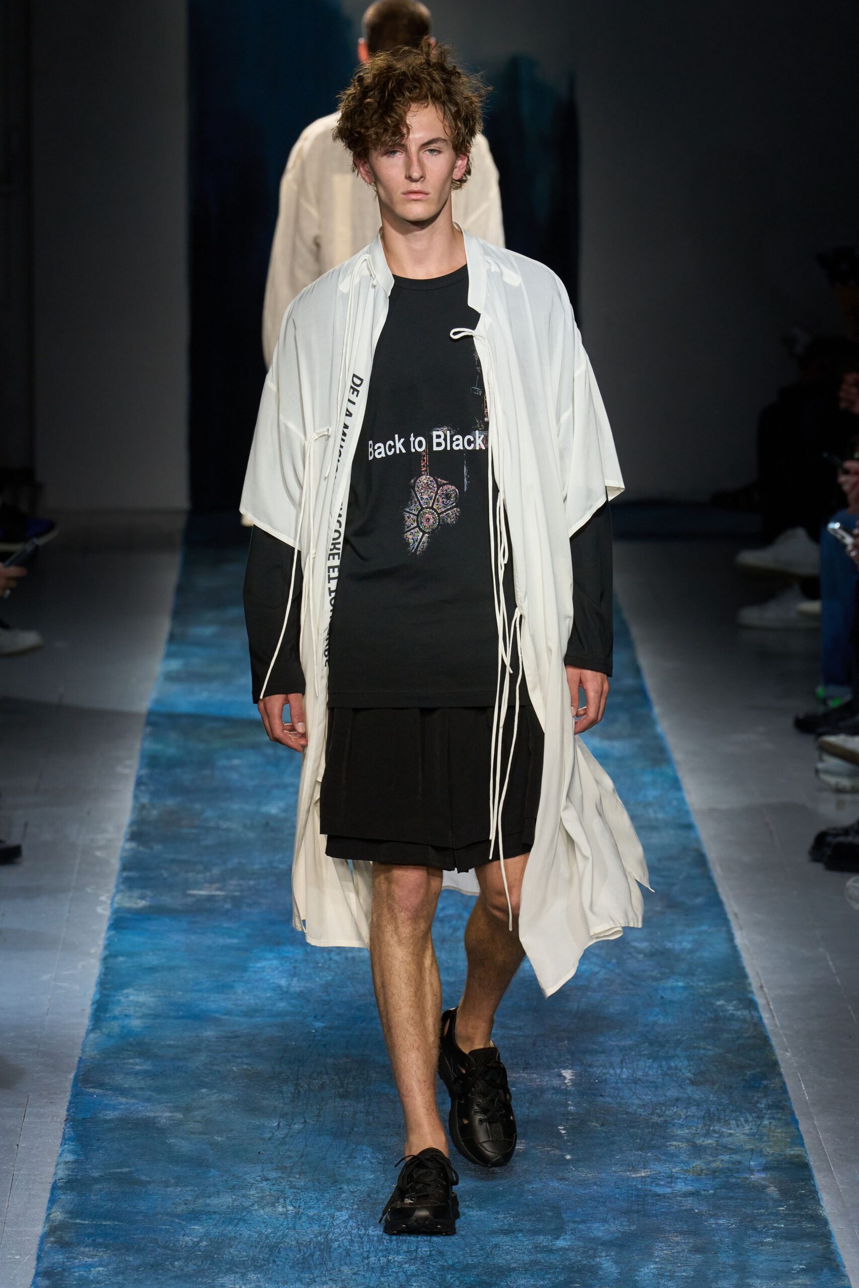 white coat black t-shirt skirt