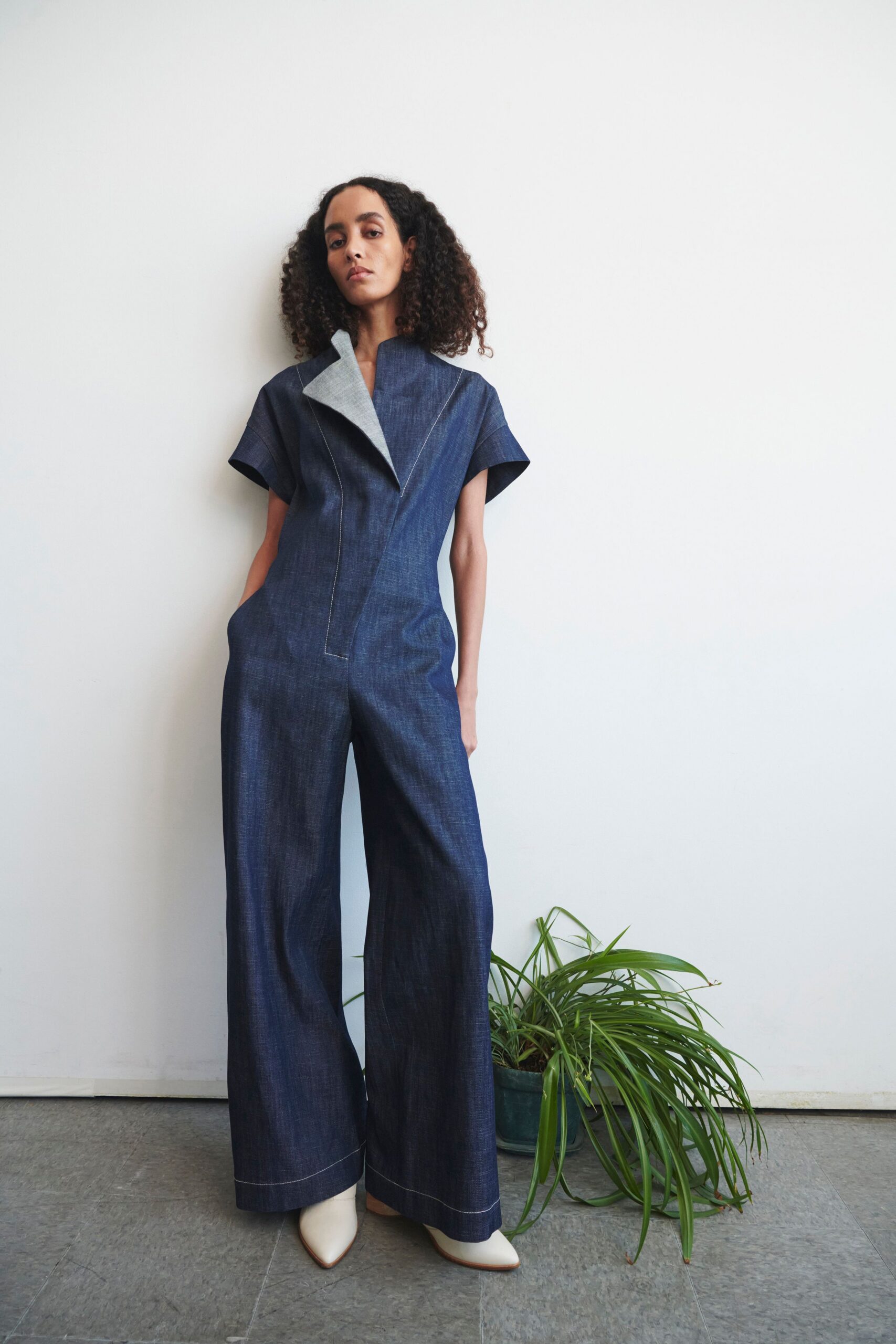 blue denim jumpsuit with white shoes
