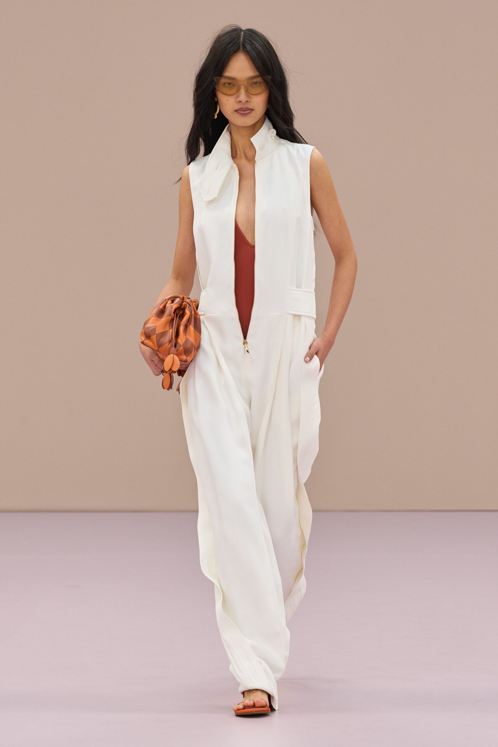 white silk sleeveless v-neck fitted zippered pleated jumpsuit