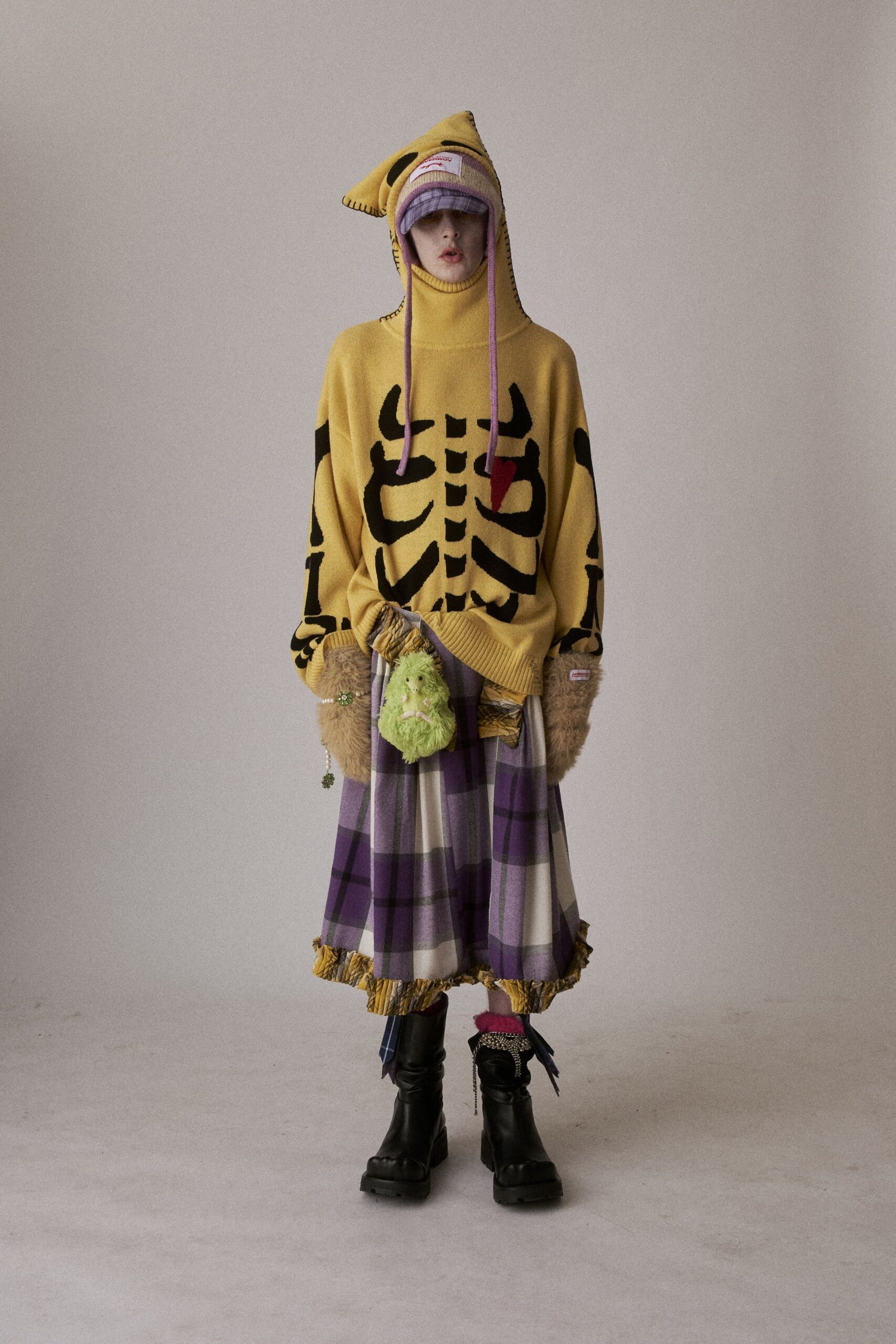 yellow oversized sweater with plaid skirt