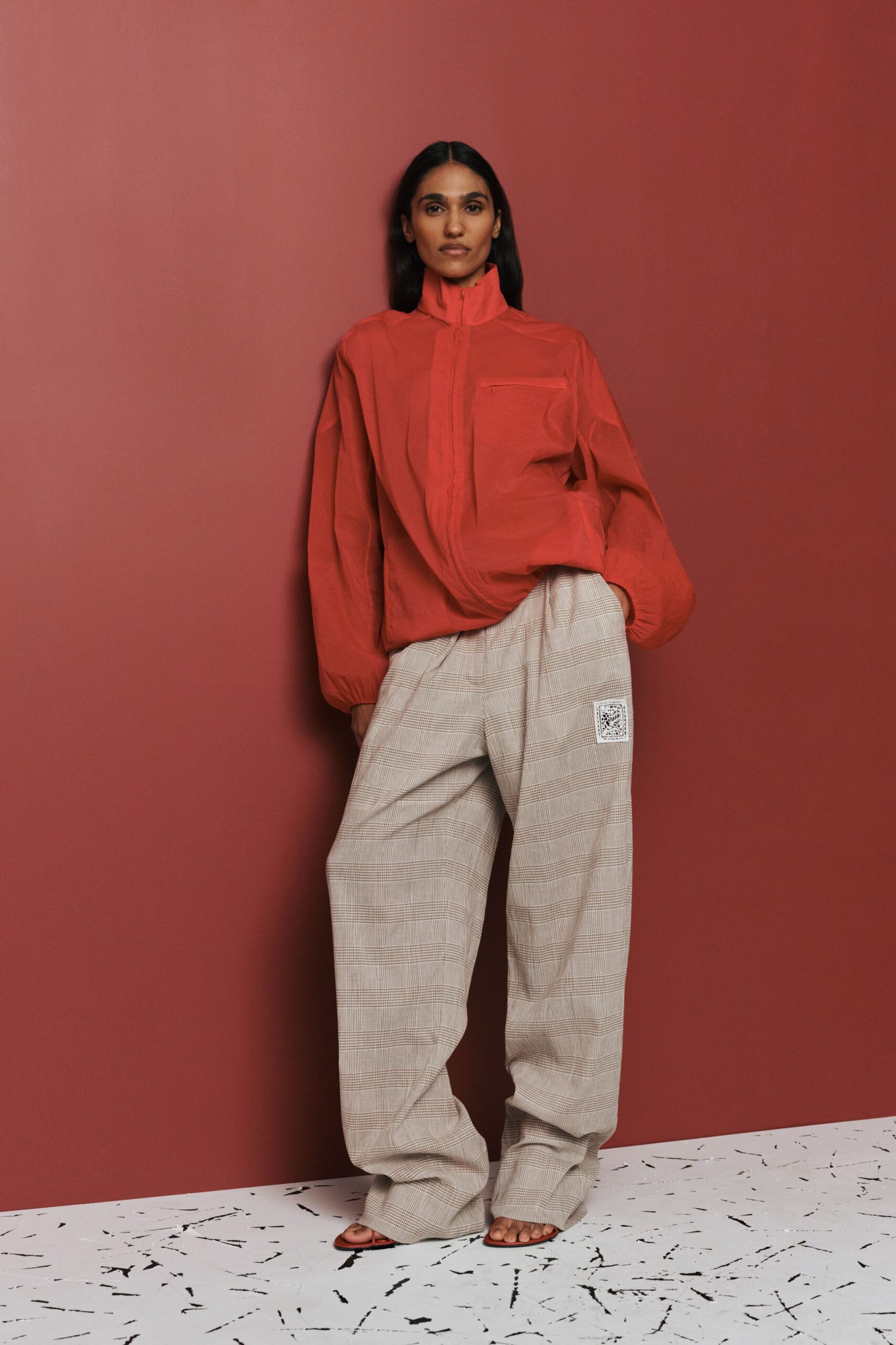 red oversized jacket with beige pants