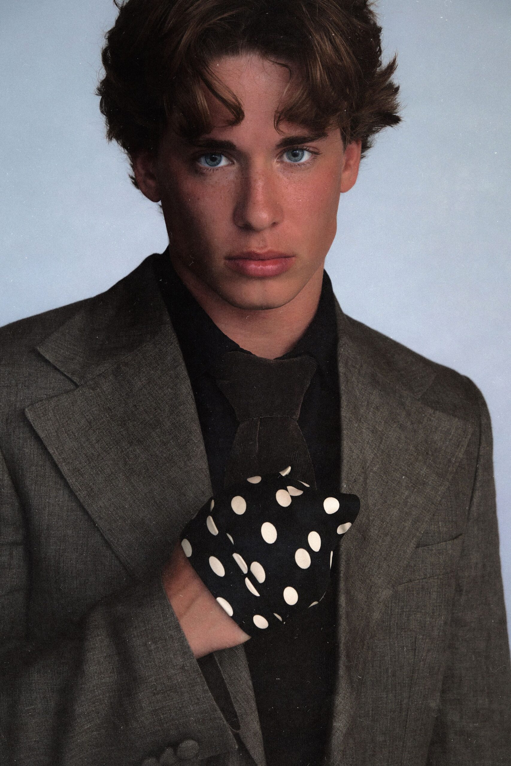 gray tailored blazer with polka-dot gloves